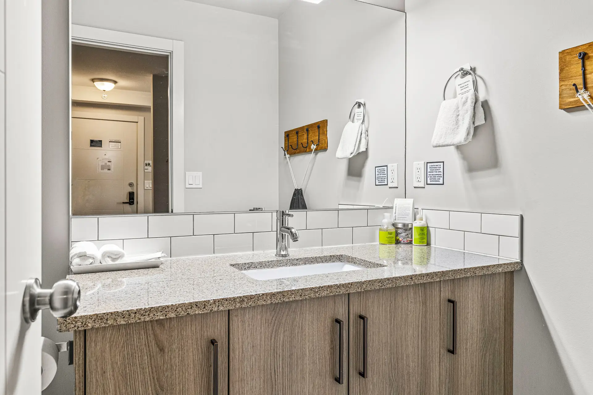 Basecamp Lodge Canmore deluxe double king room bathroom with granite vanity and towels