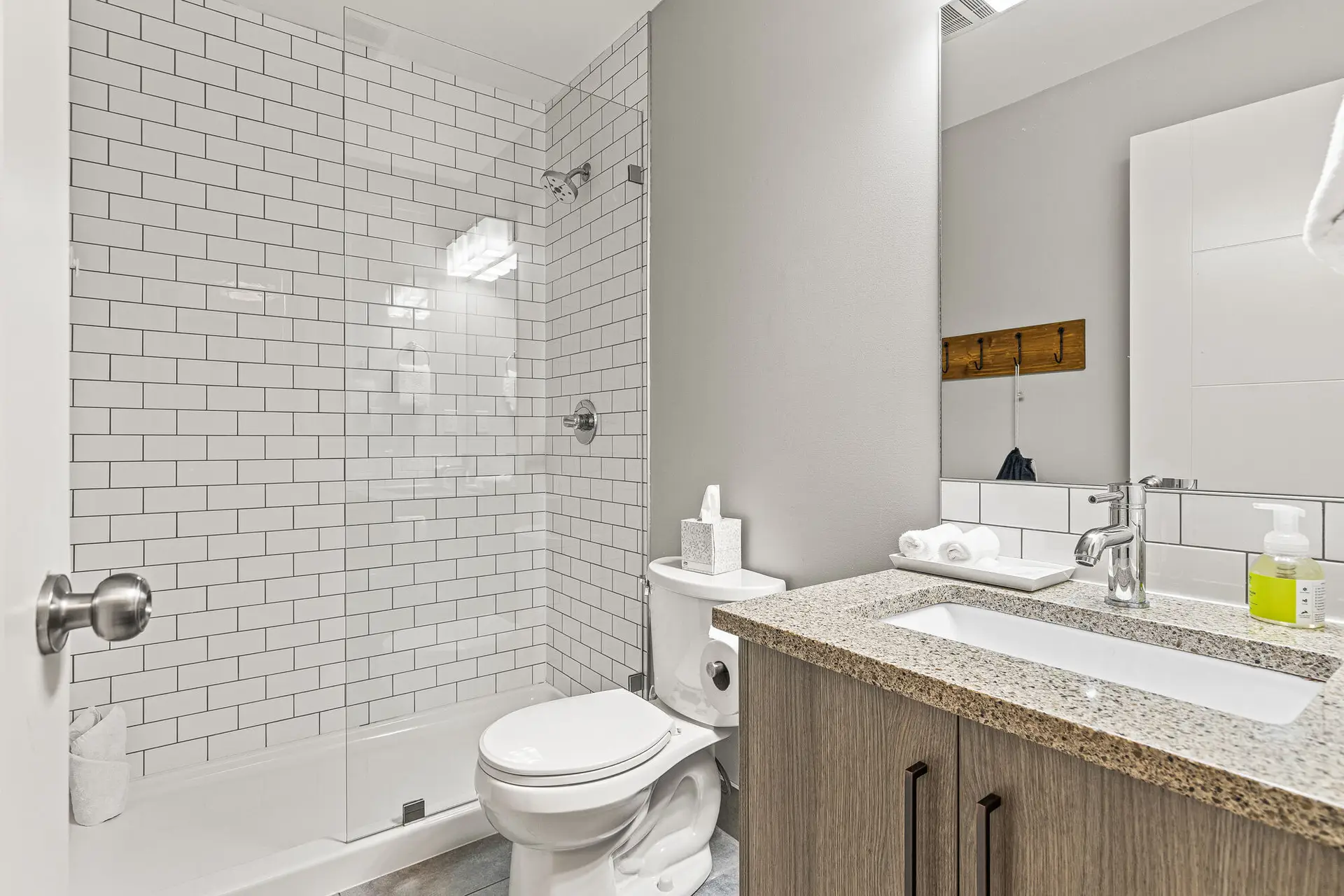 Modern bathroom in Basecamp Lodge Canmore micro suite with shower, toilet, and vanity.