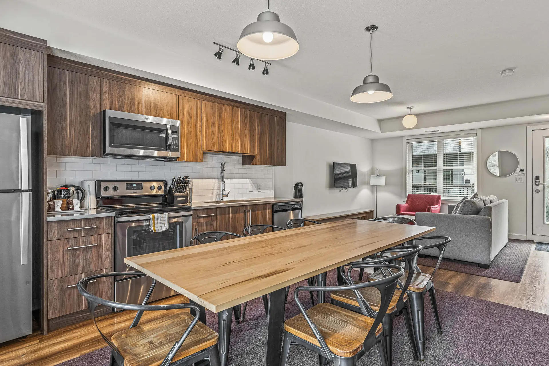 Modern kitchen and dining area in Basecamp Resorts Canmore three-bedroom suite