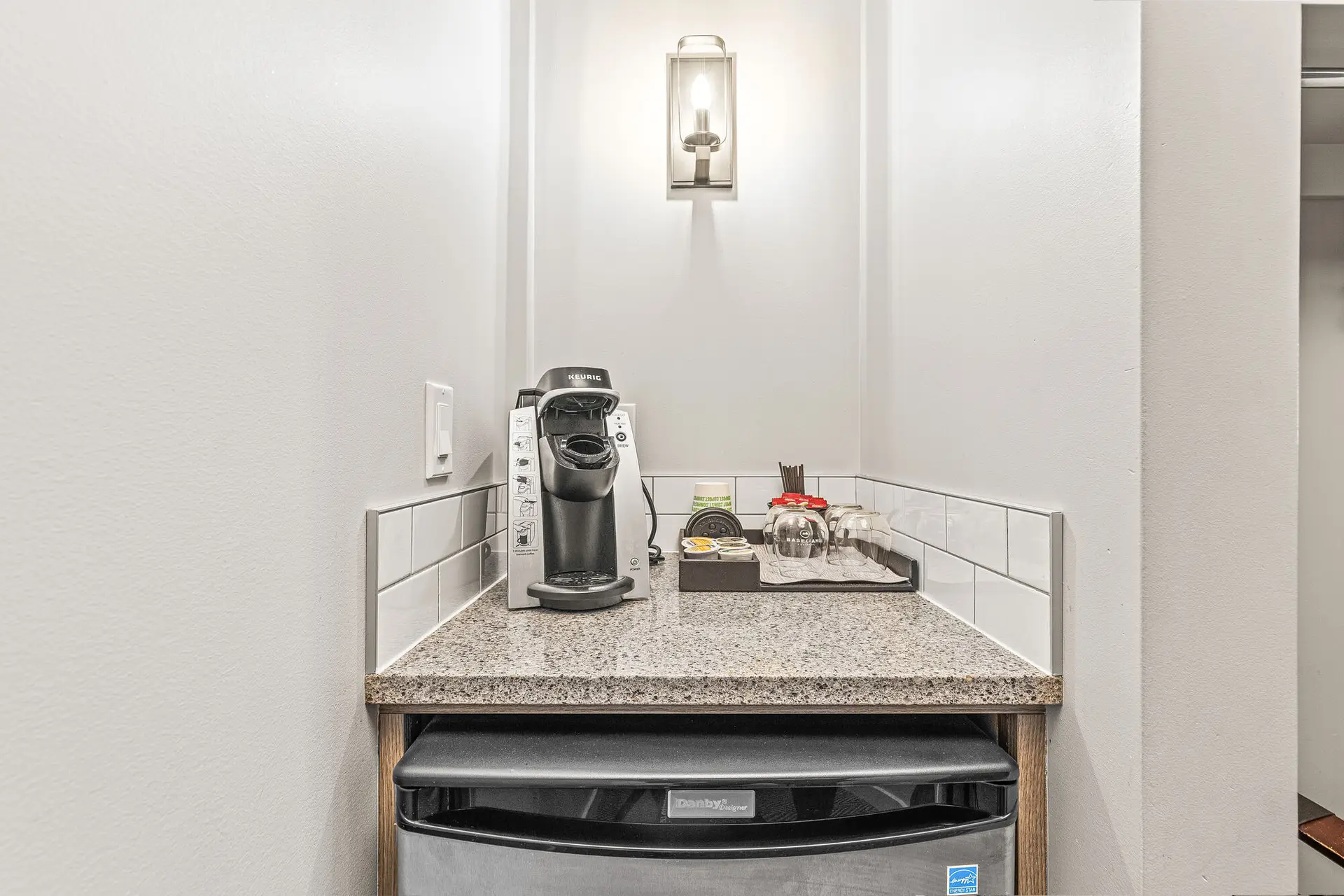 King Suite coffee station with Keurig, mini-fridge, and amenities.