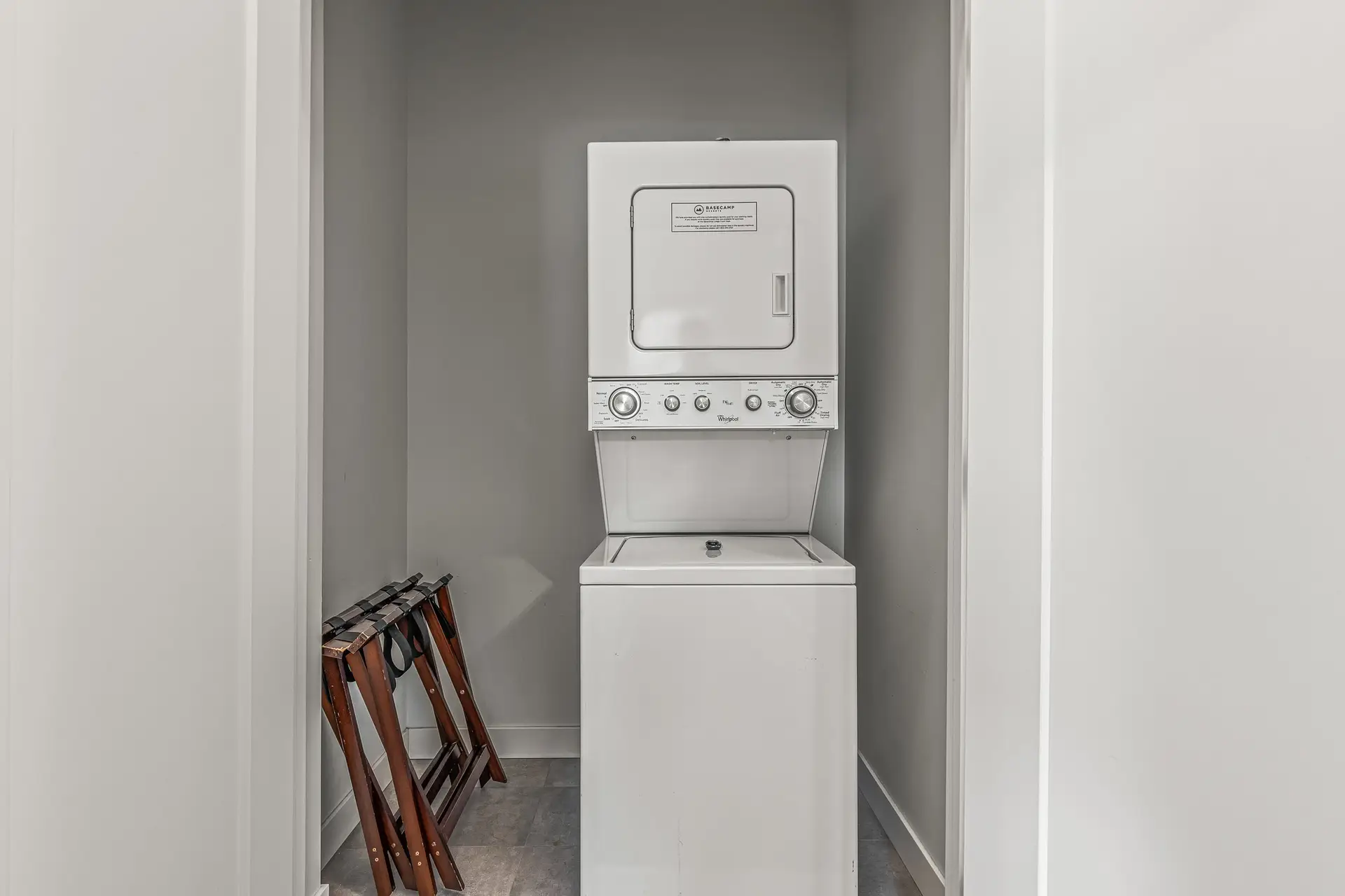 Stacked Whirlpool washer and dryer in a laundry closet at Basecamp Resorts Canmore