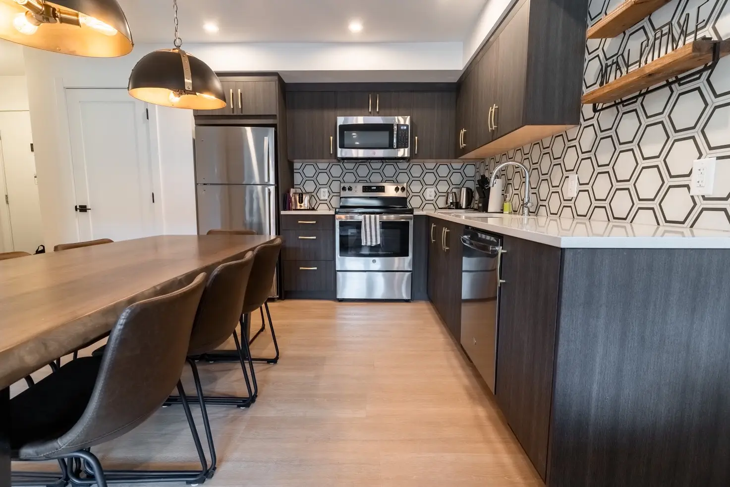 Basecamp Suites Canmore three-bedroom apartment kitchen with modern appliances and dining area.