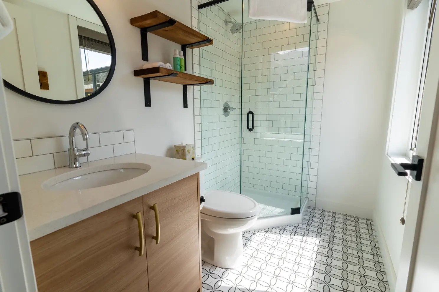 Modern bathroom with shower, toilet, and vanity in Basecamp Suites Canmore two-bedroom suite.