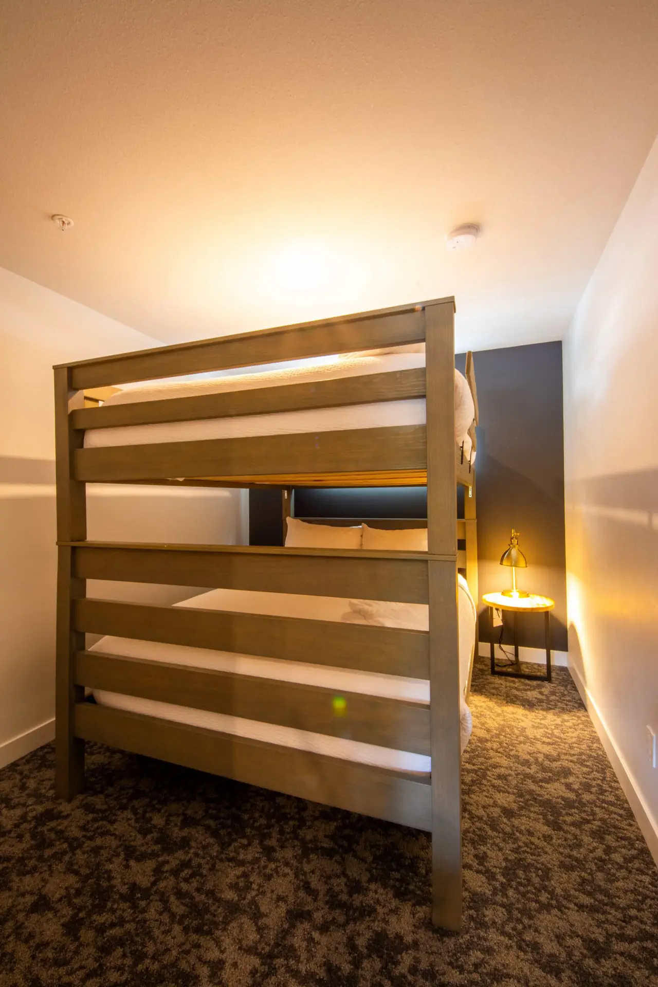 Bunk suite in Basecamp Resorts Revelstoke three-bedroom with cozy bunk beds.