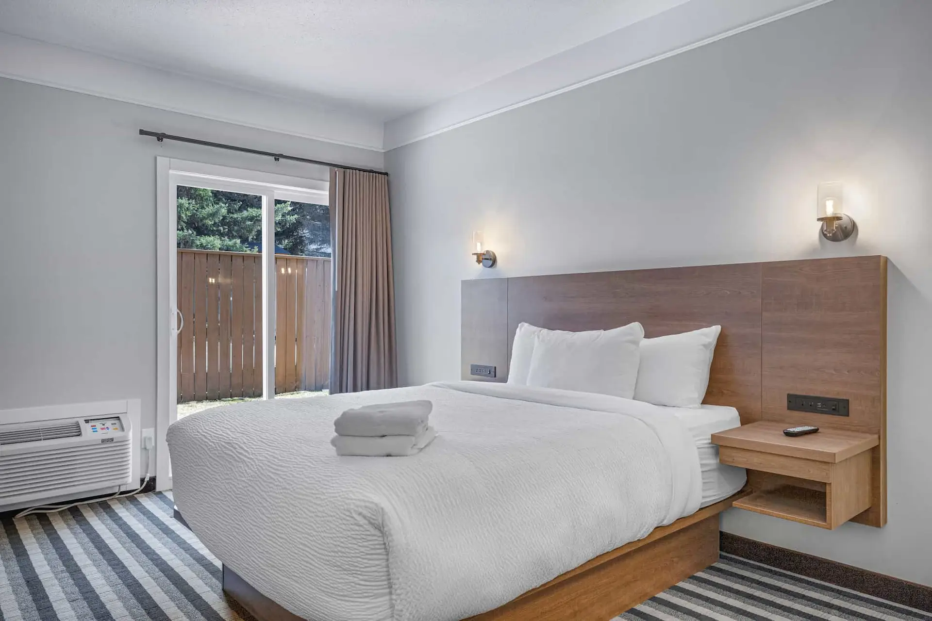 Deluxe King Room at Basecamp Northwinds Canmore with king bed and patio access.