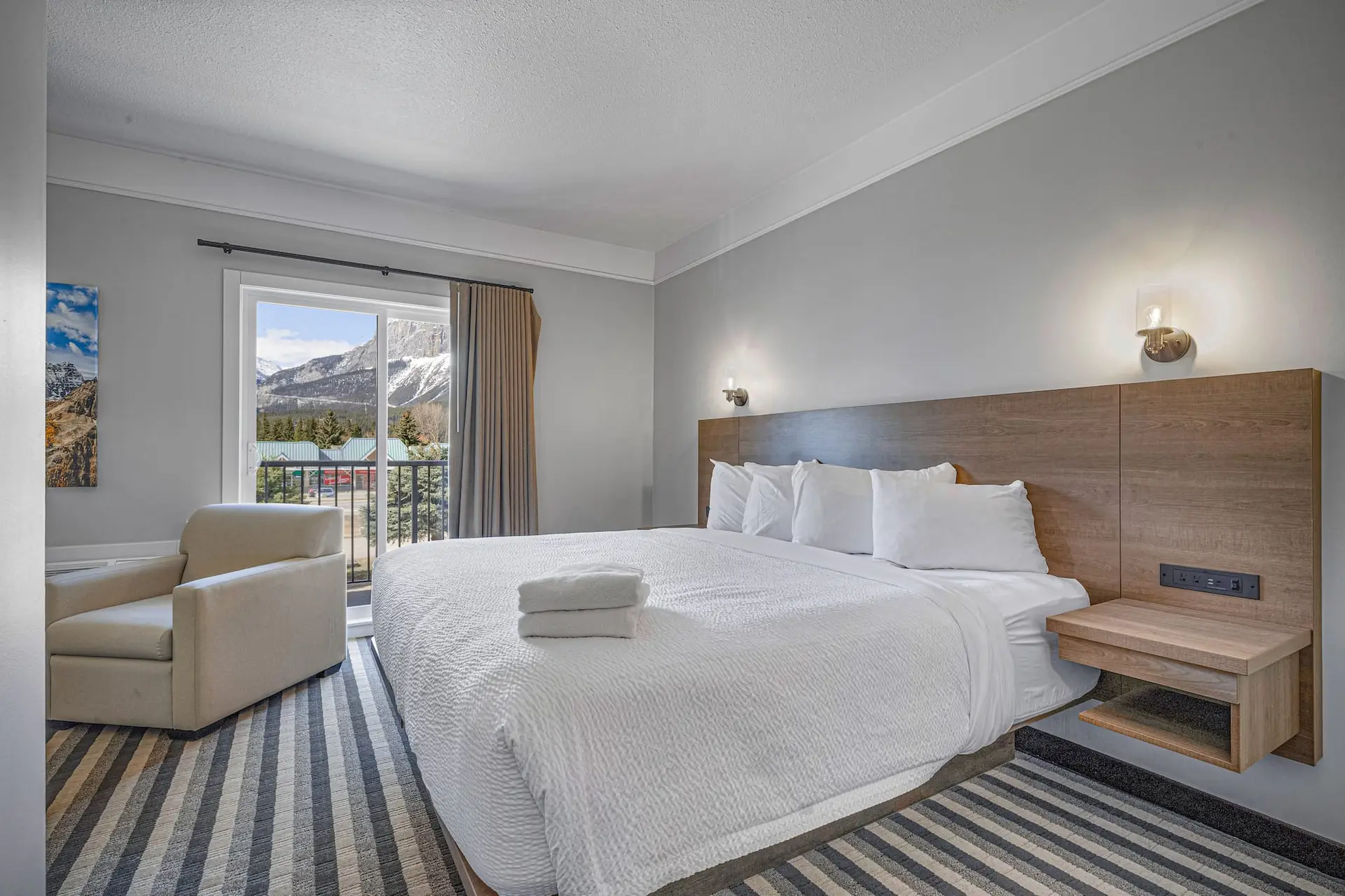 King bed in Basecamp Northwinds Canmore hotel room with mountain view