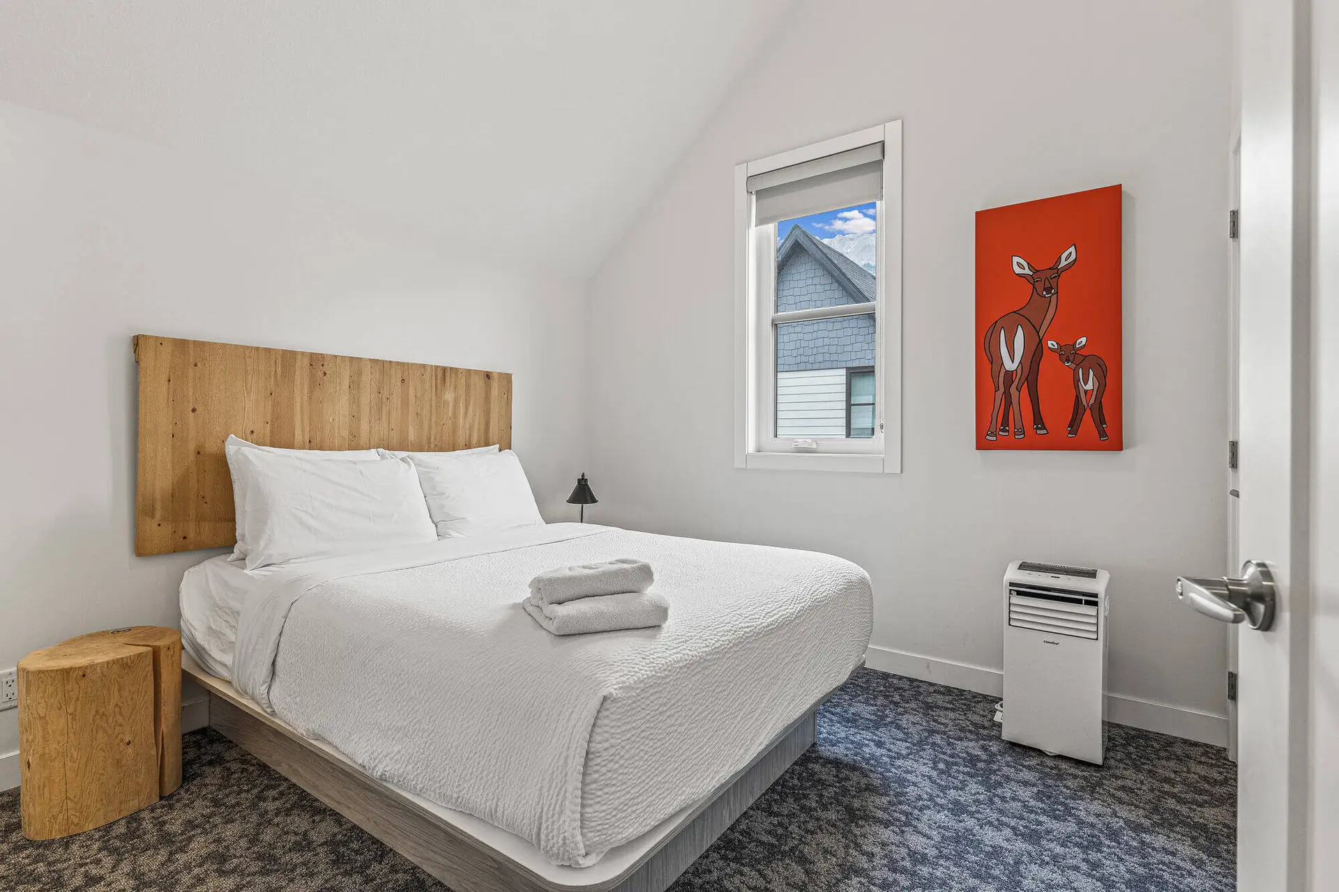 Five bedroom suite at Basecamp Resorts Canmore: cozy bedroom with deer art.
