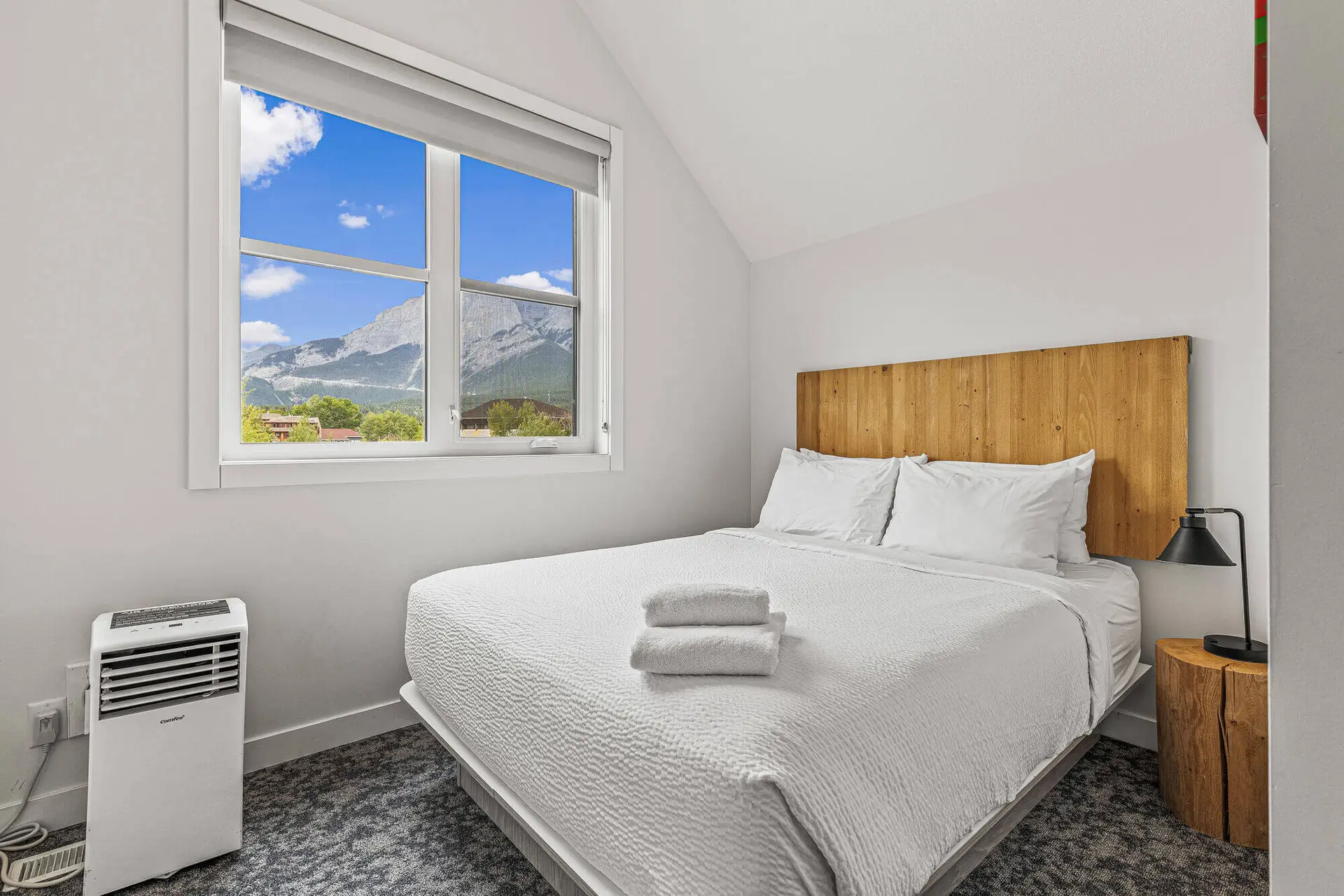 Bedroom in Canmore resort suite with mountain view and queen bed