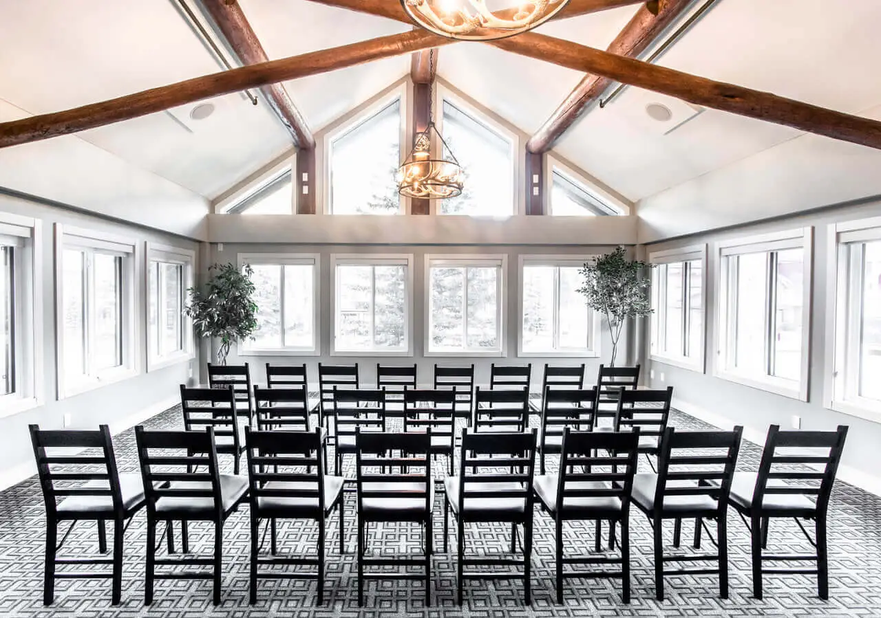Basecamp Lodge Canmore event space with chairs arranged for a ceremony.