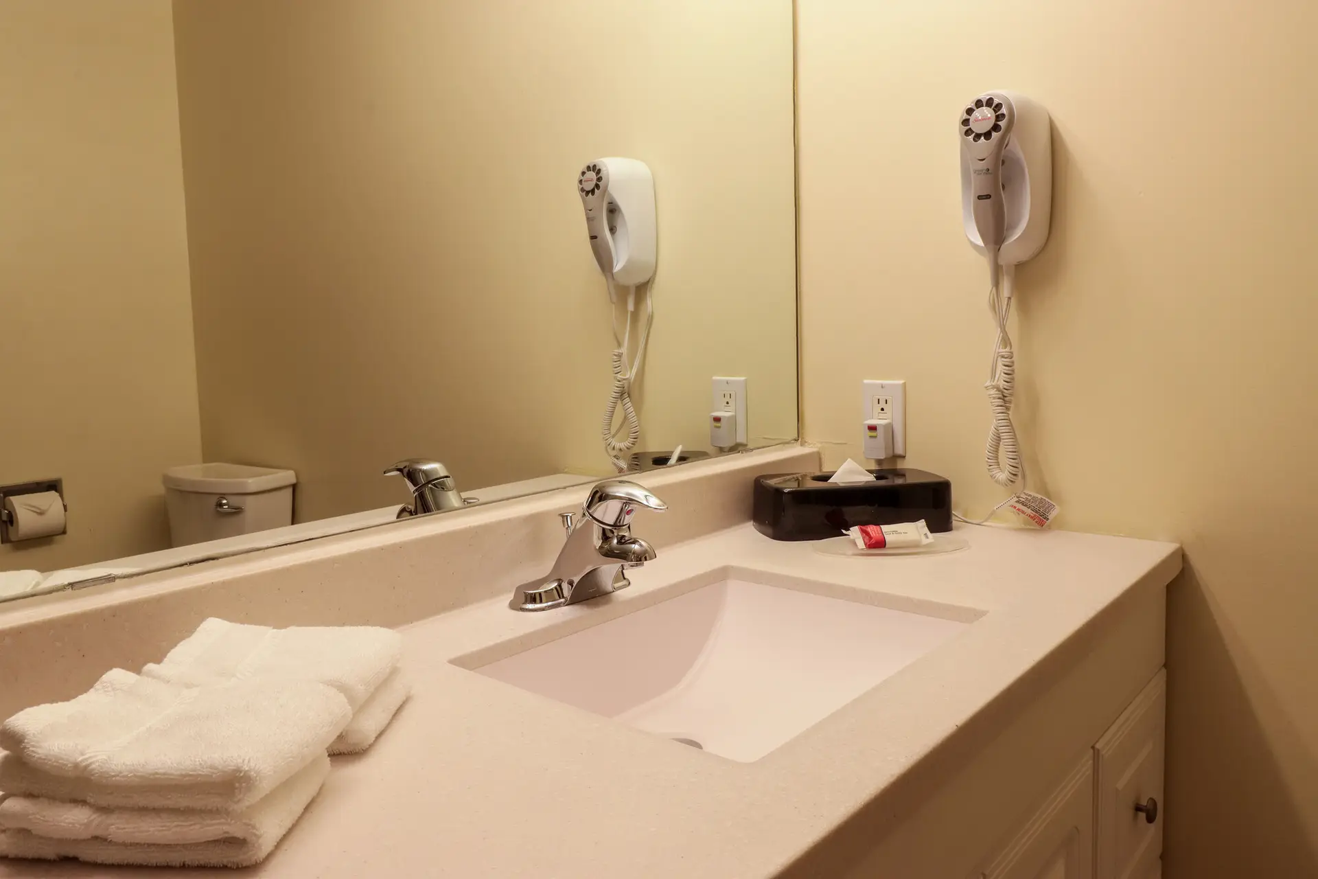 Revelstoke Northwinds apartment bathroom with sink, hairdryer, and toiletries