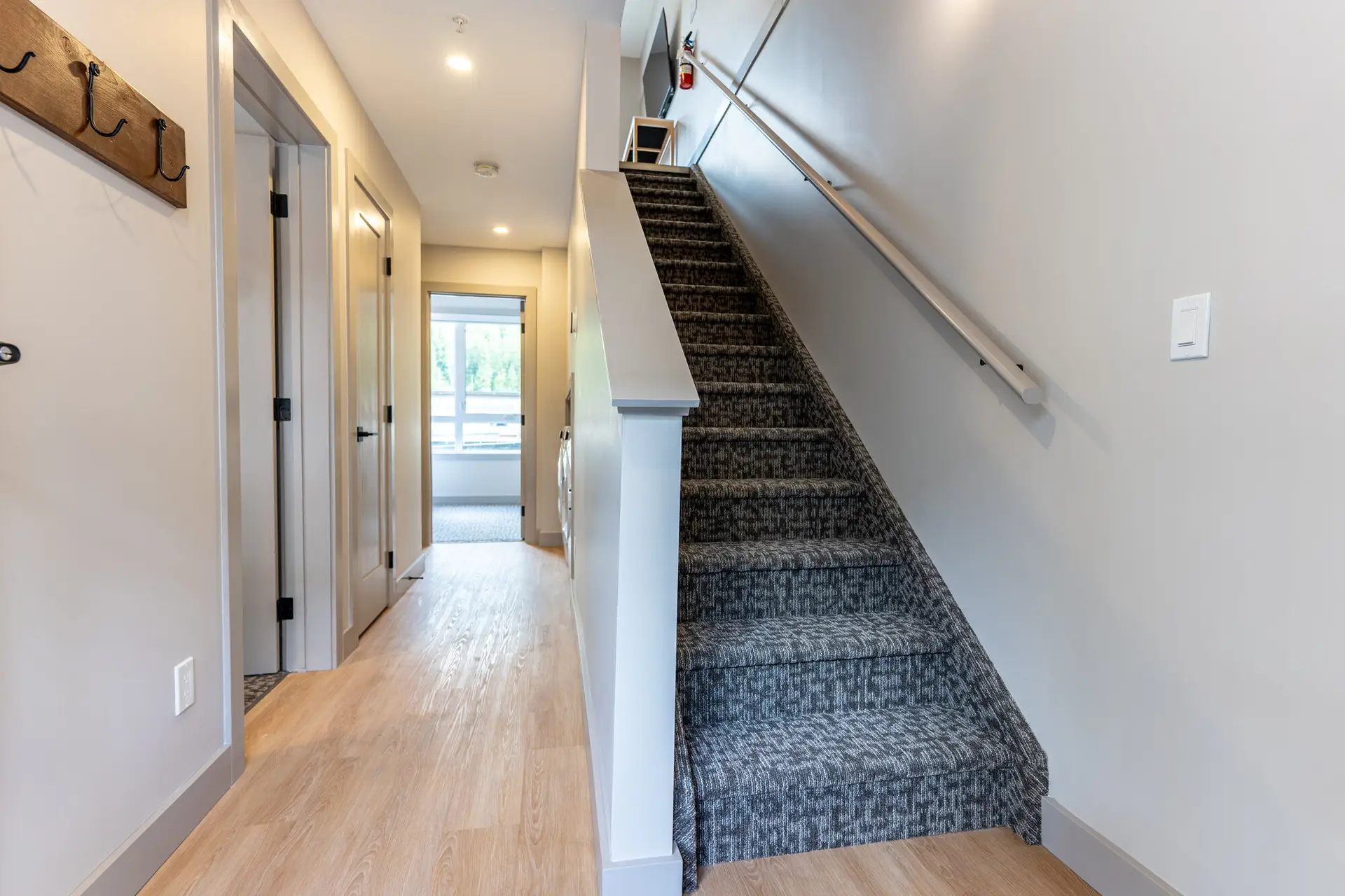 Interior hallway and staircase of a modern suite at Basecamp Suites Revelstoke.