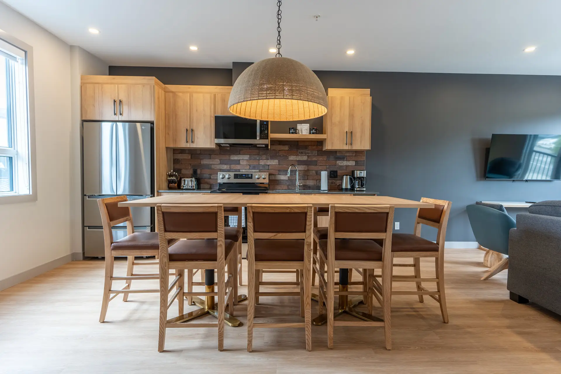 Modern kitchen and dining area in a Basecamp Suites Revelstoke four-bedroom suite.