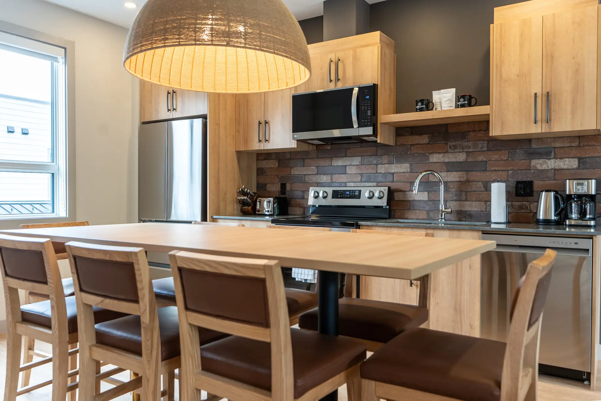 Modern kitchen with island and seating in Basecamp Suites Revelstoke