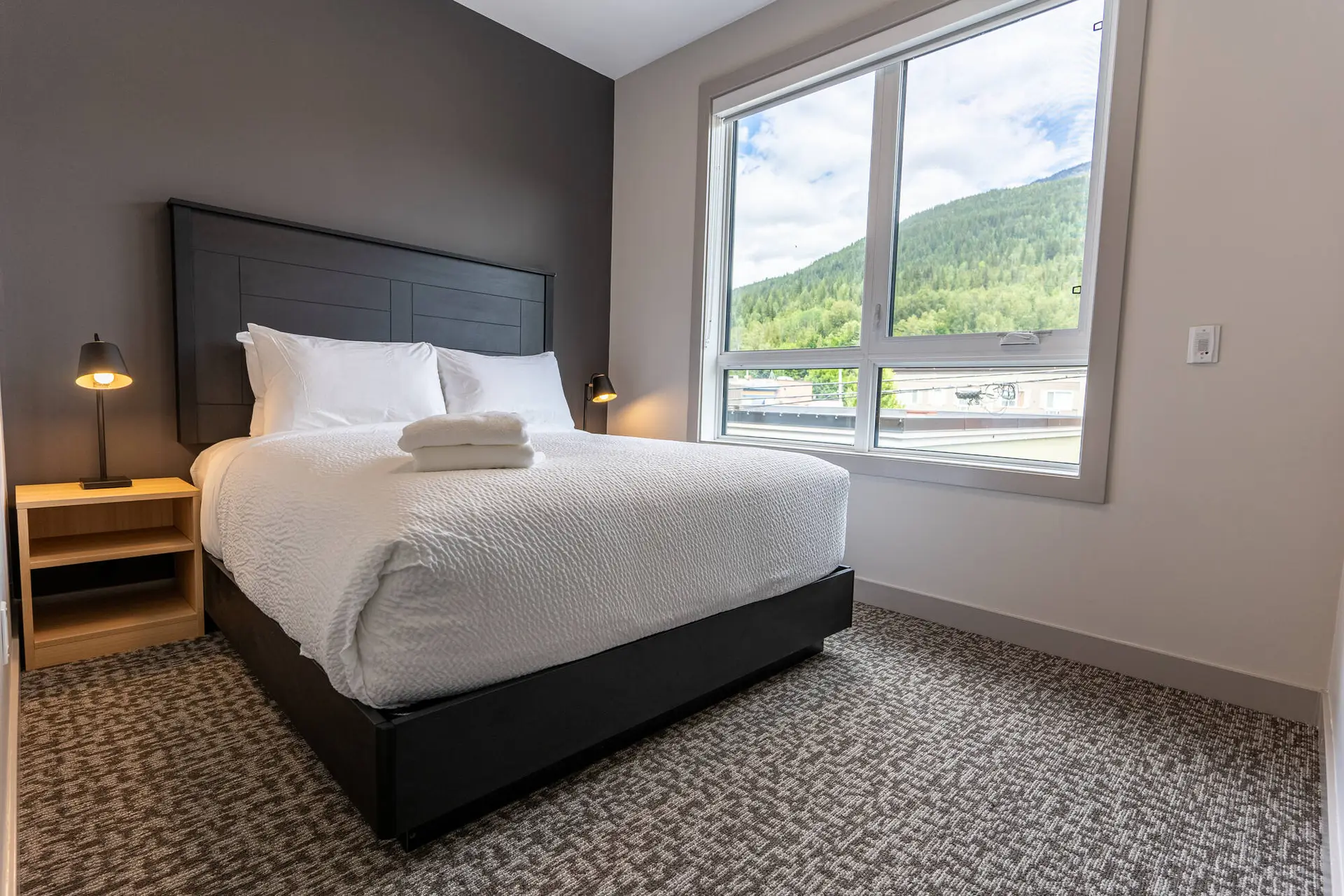 Revelstoke basecamp Suites six-bedroom suite with king bed and mountain view.