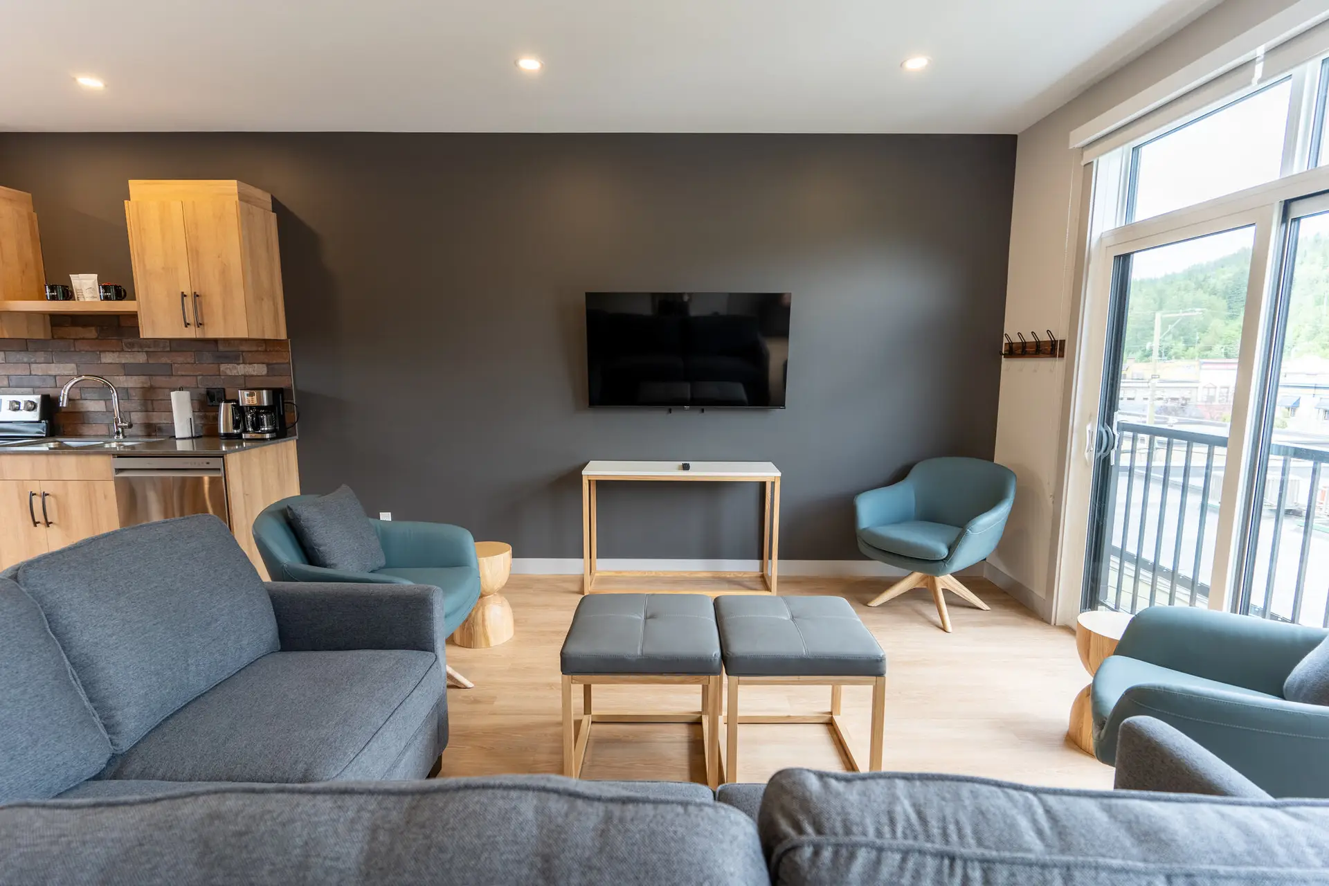 Basecamp Suites Revelstoke six-bedroom suite living area with modern furniture.