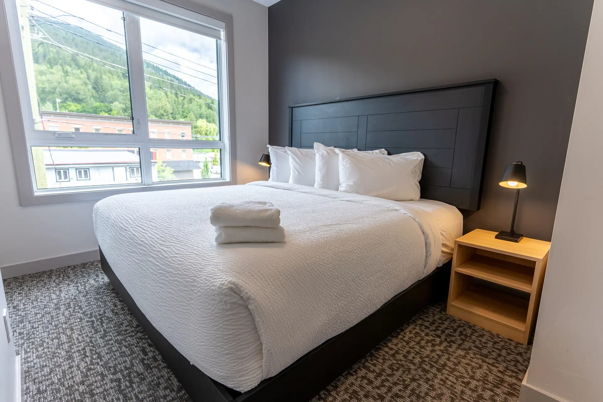 Basecamp Suites Revelstoke six-bedroom suite with king bed and mountain view