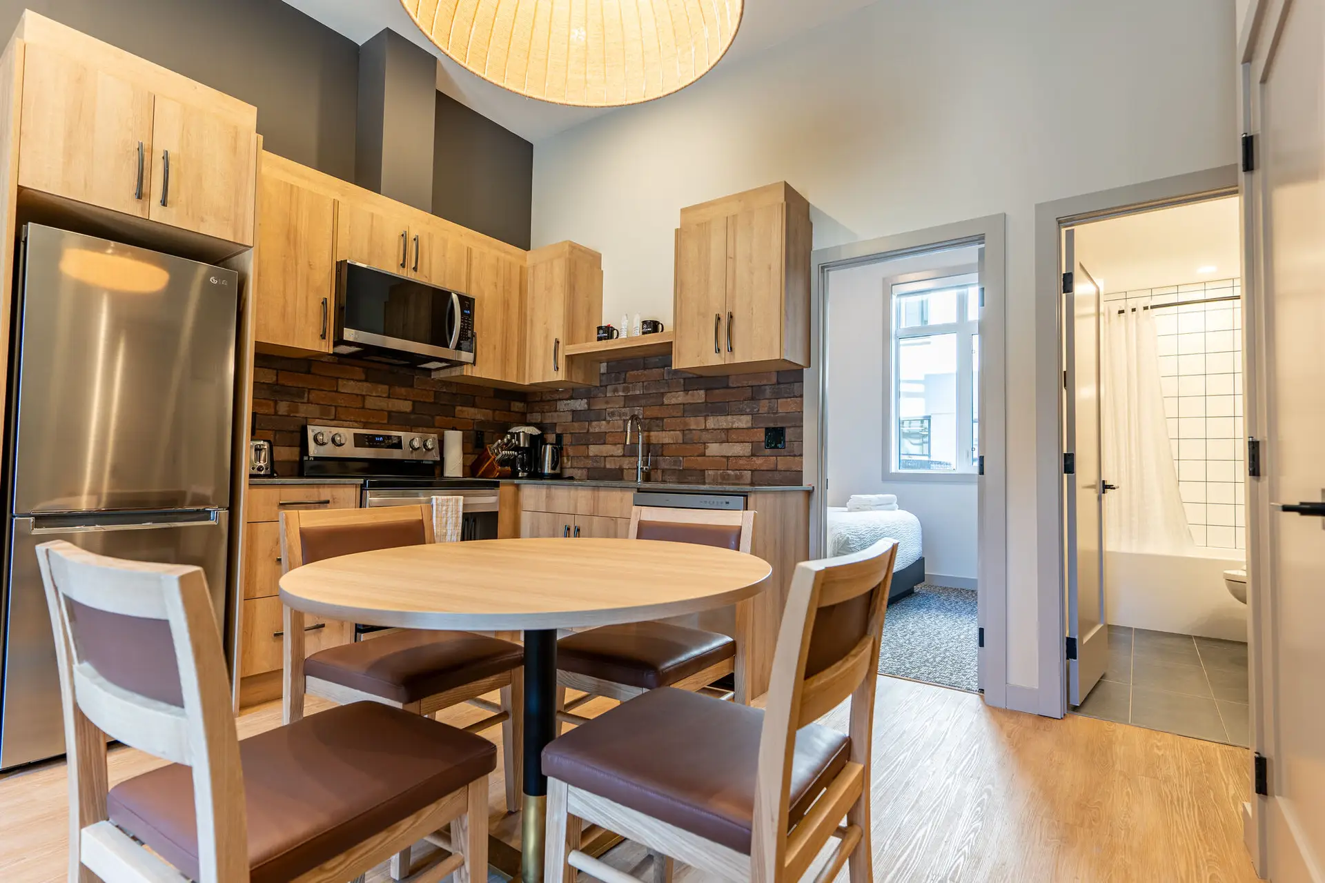Kitchen and dining area of a Basecamp Suites Revelstoke four-bedroom suite.