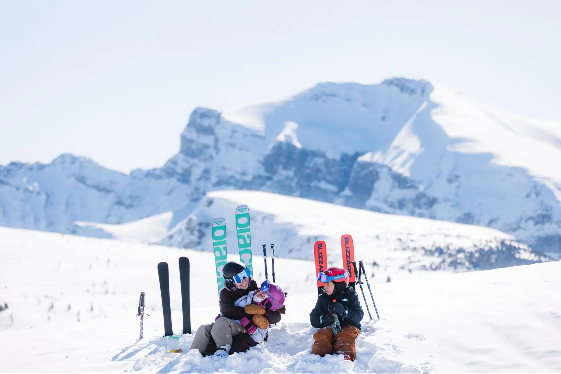 Family enjoying the Canadian Rockies ski season with snowy mountains