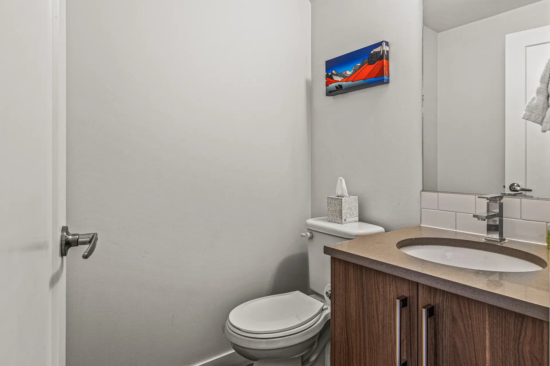 Powder room in Basecamp Resorts Canmore Three Bedroom Suite with toilet and vanity.
