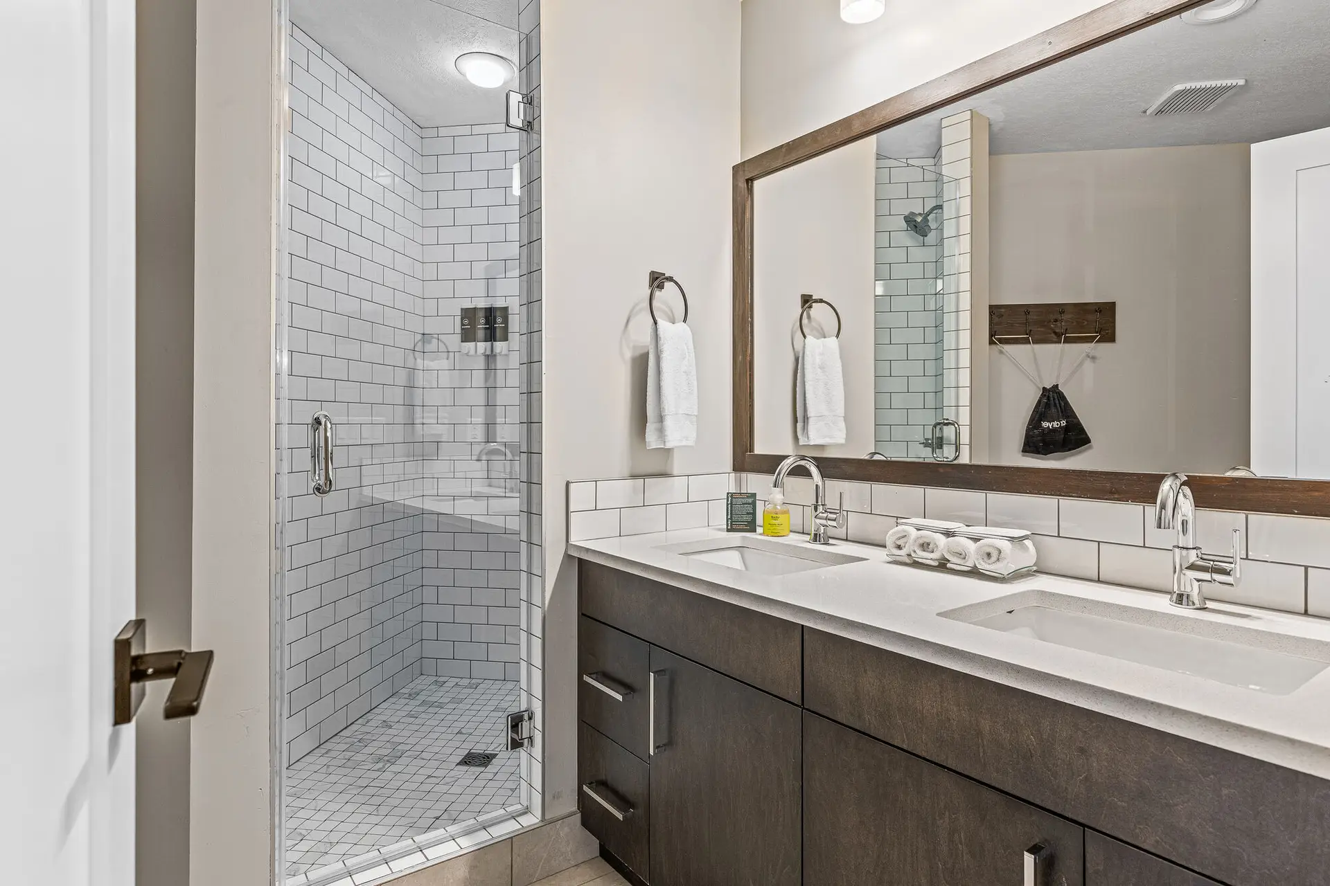 Modern bathroom with double vanity, walk-in shower, and stylish finishes at Basecamp Northwinds Canmore