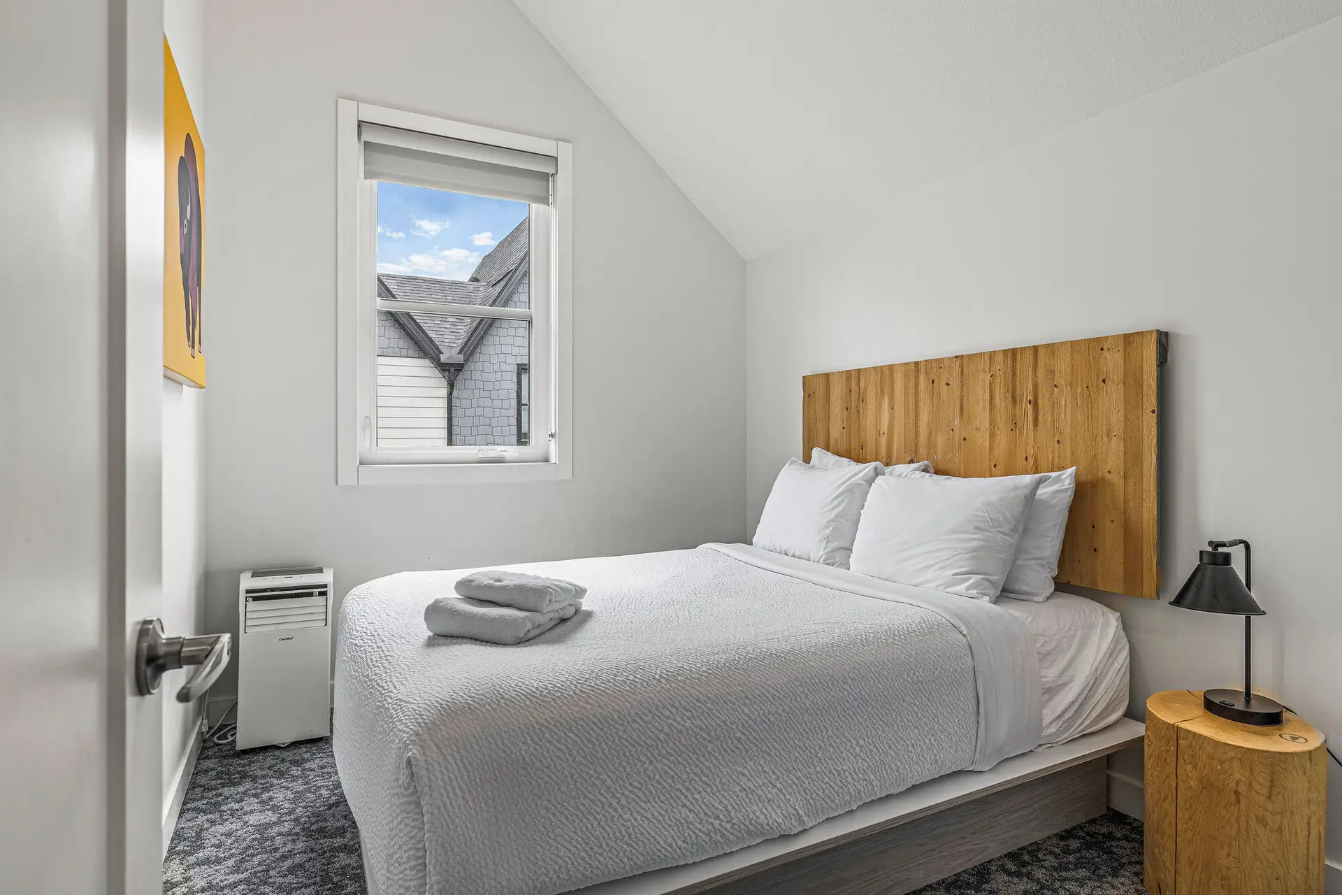 Cozy bedroom in Basecamp Resorts Canmore Three Bedroom Suite with a queen bed.