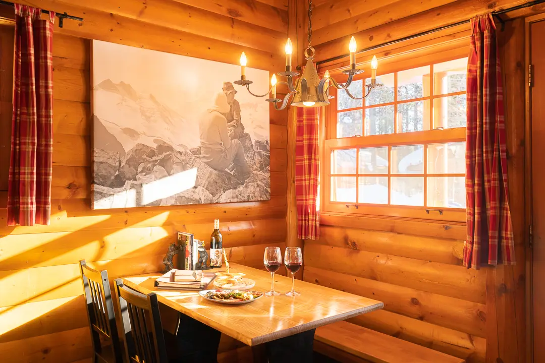 Cozy dining nook in Basecamp Baker Creek cabin with mountain art