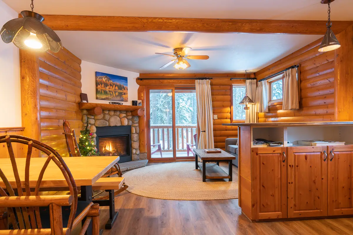 Cozy living area of Basecamp Baker Creek suite with fireplace and mountain view