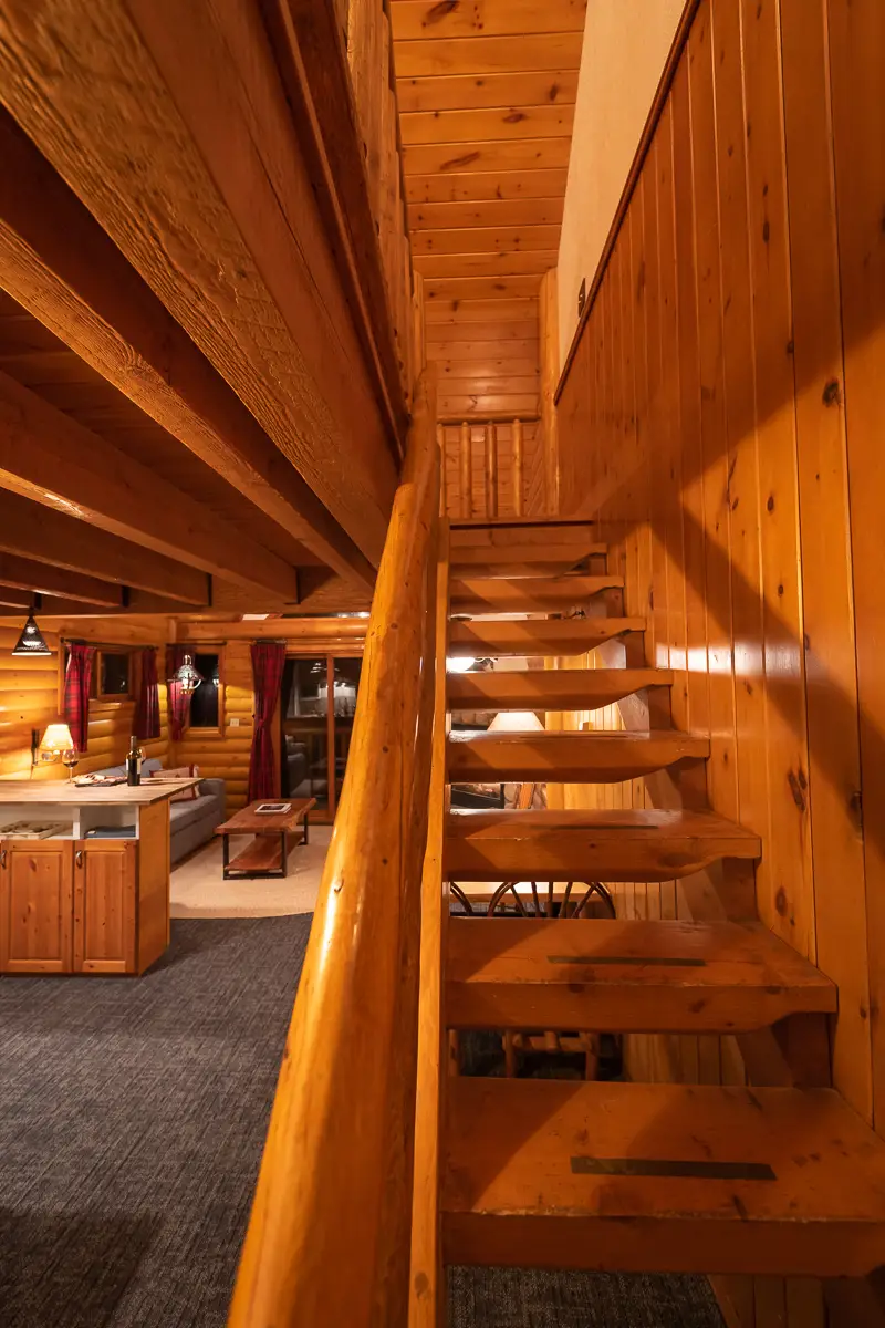 Wooden staircase in Basecamp Baker Creek Superior Jacuzzi Suite