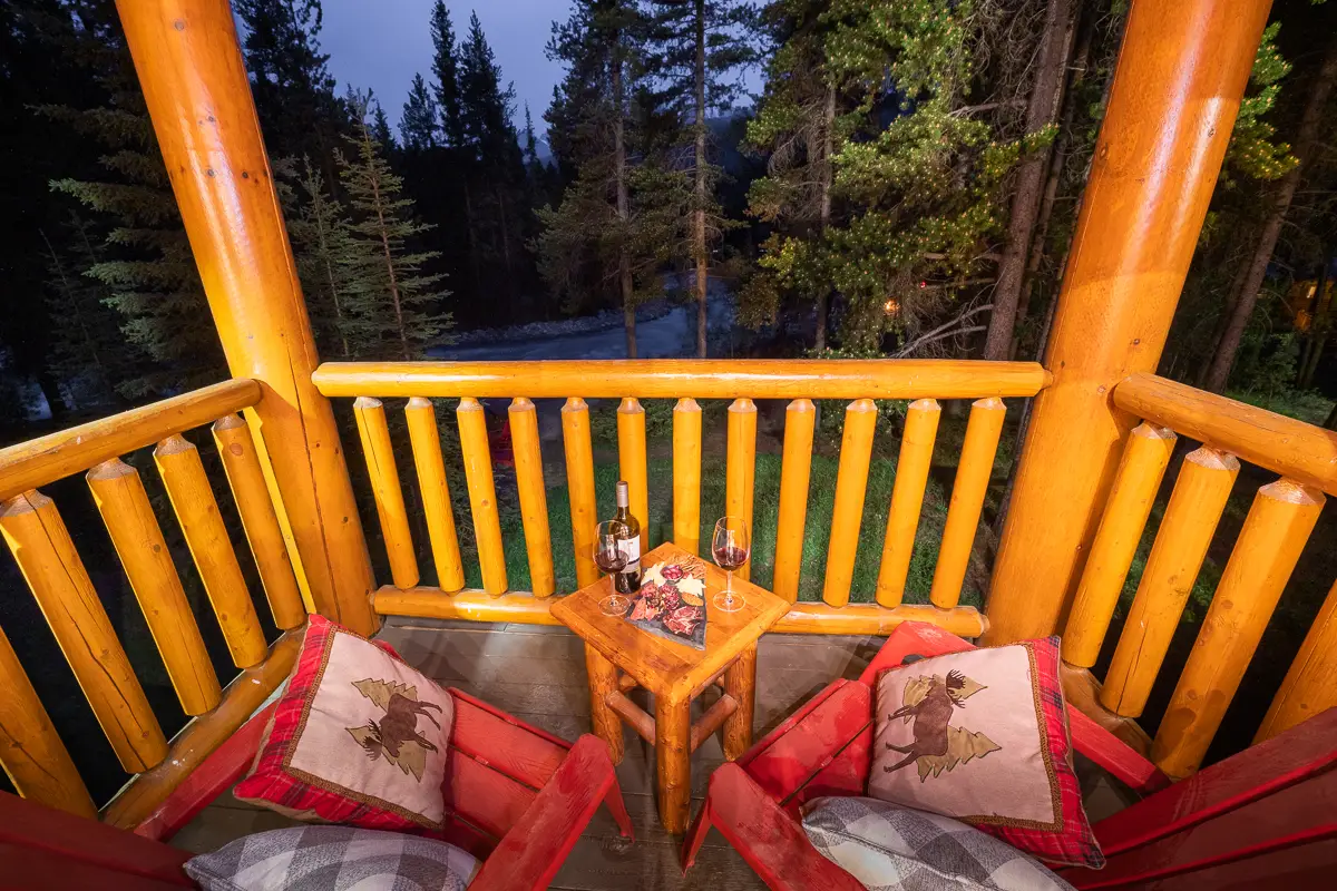 Balcony of Basecamp Baker Creek Jacuzzi Suite with wine and forest view
