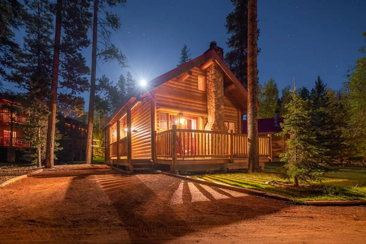 Basecamp Baker Creek Queen Cabin at night, illuminated by moonlight and exterior lights.