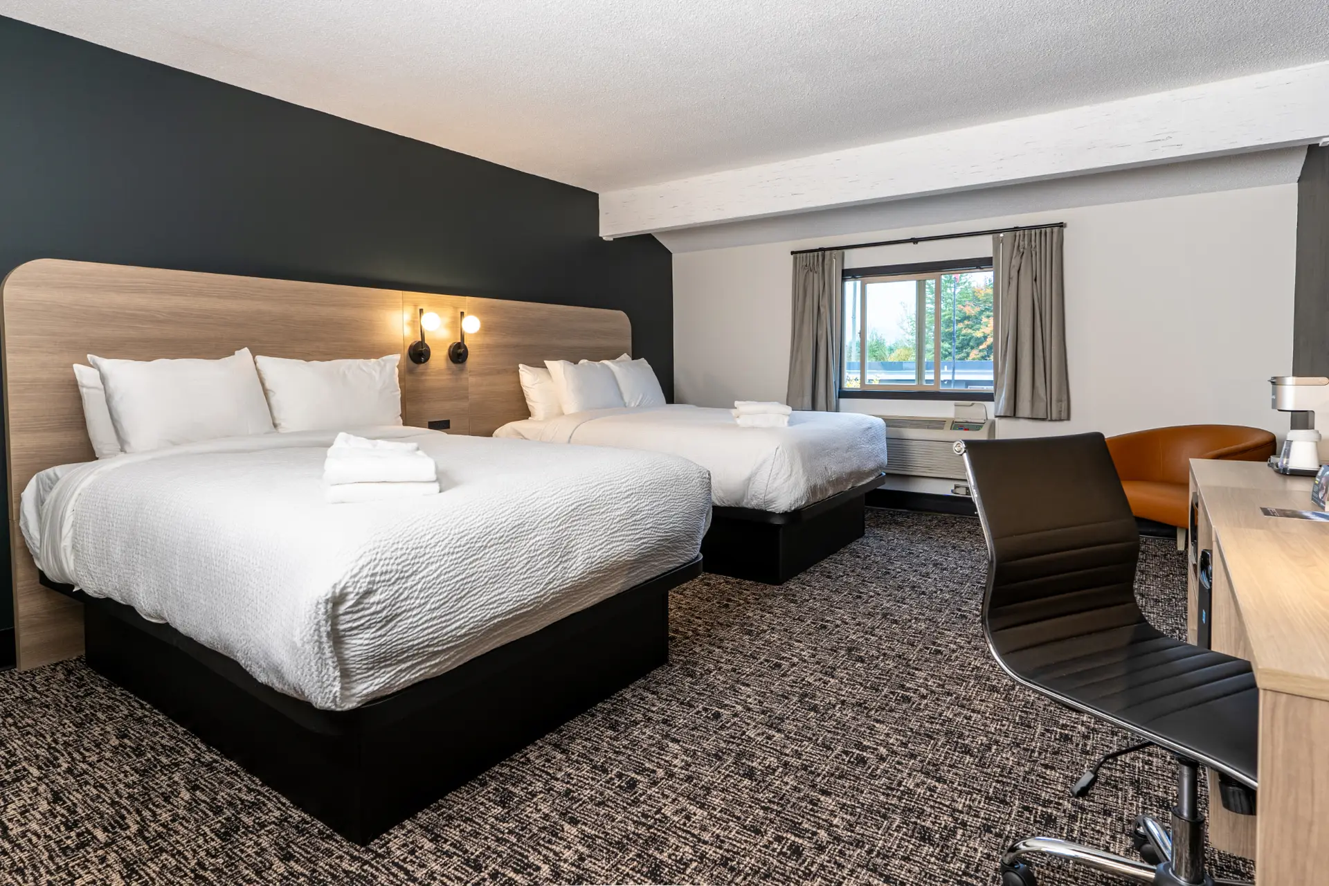 Basecamp Northwinds Revelstoke: Double Queen room with two beds, modern decor, and desk.