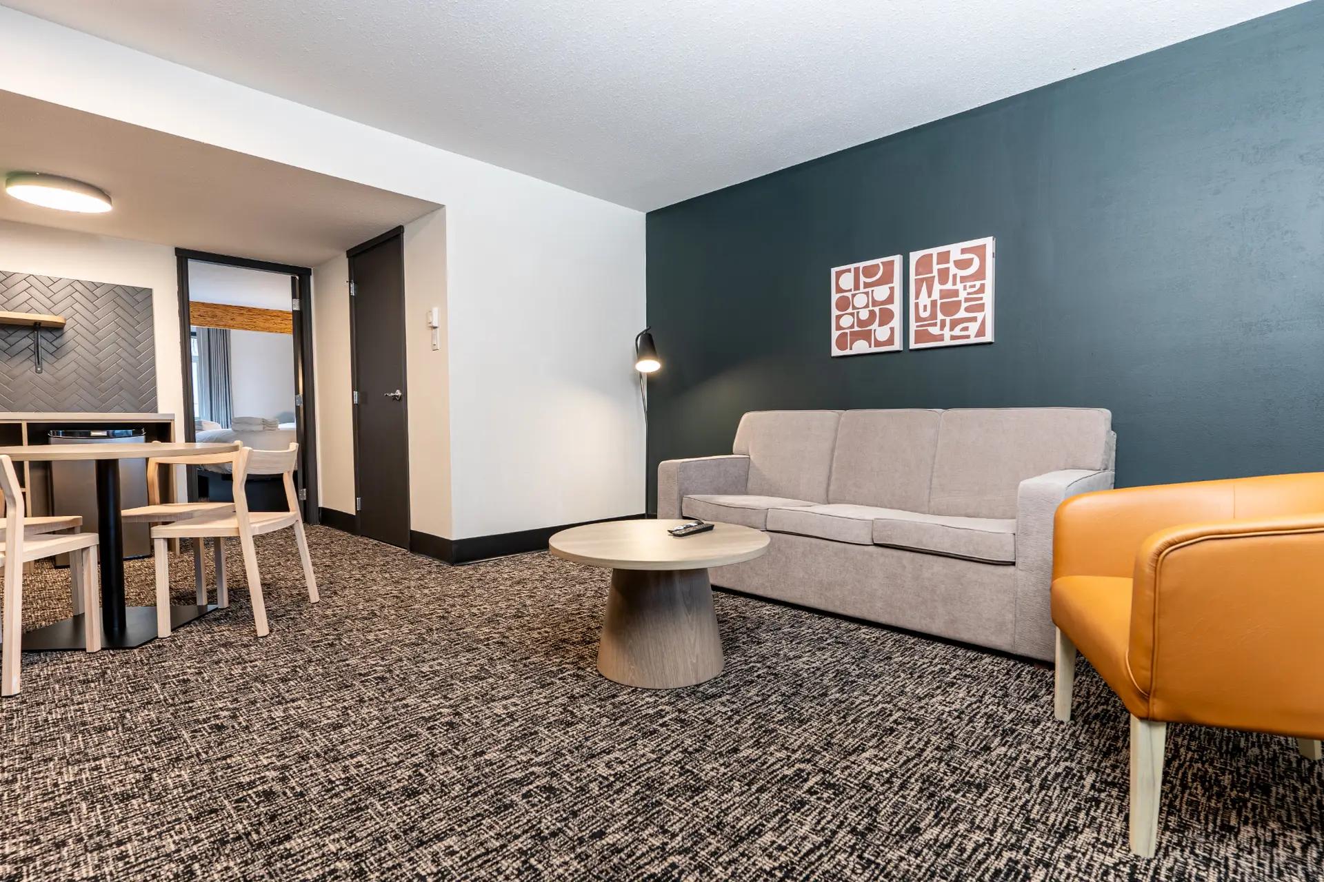 Basecamp Northwinds Revelstoke: Double Queen Suite living area with sofa and armchair
