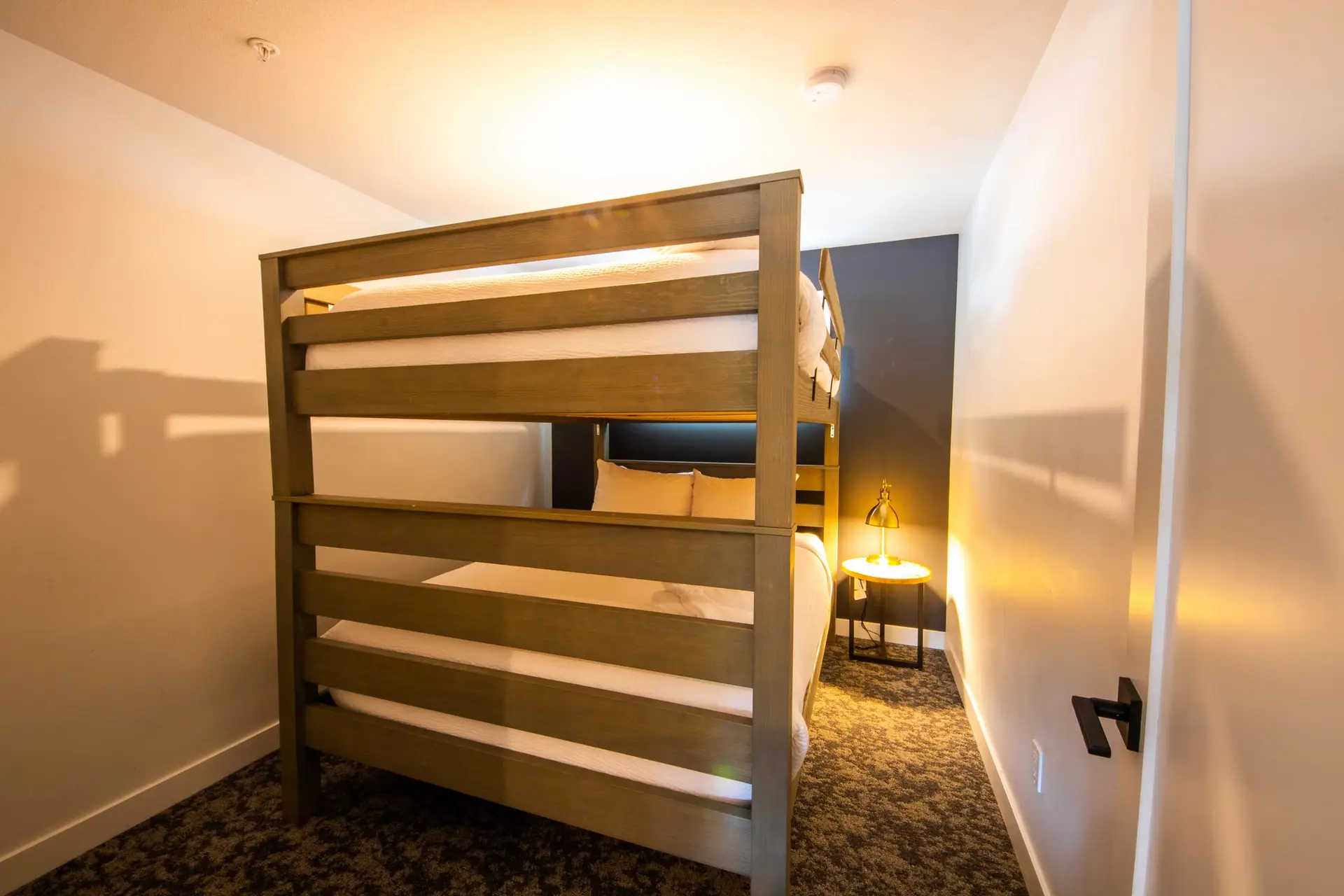 Bunk suite in Basecamp Resorts Revelstoke Three Bedroom with wooden bunk beds.