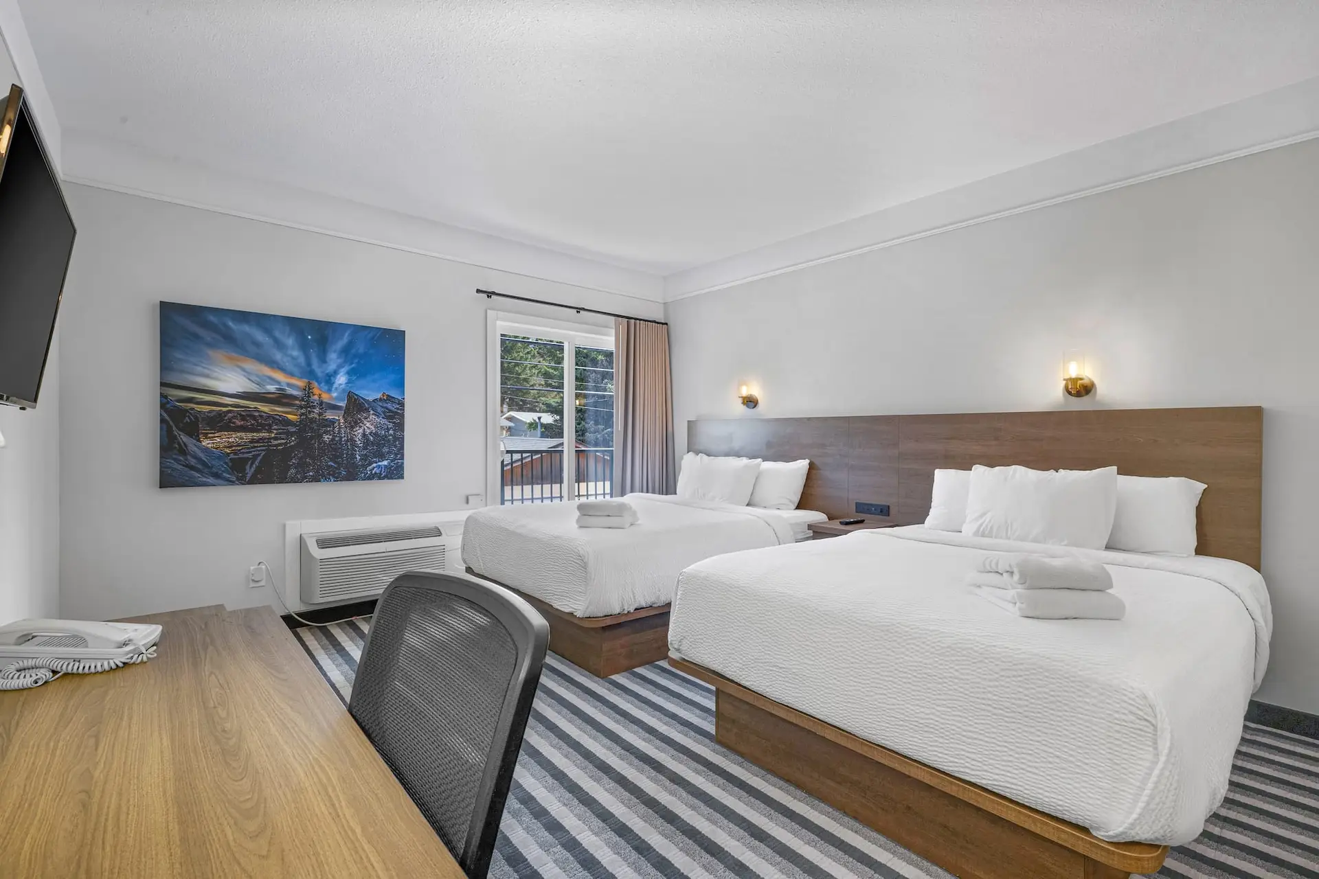 Basecamp Northwinds Canmore double queen room with desk and mountain art.