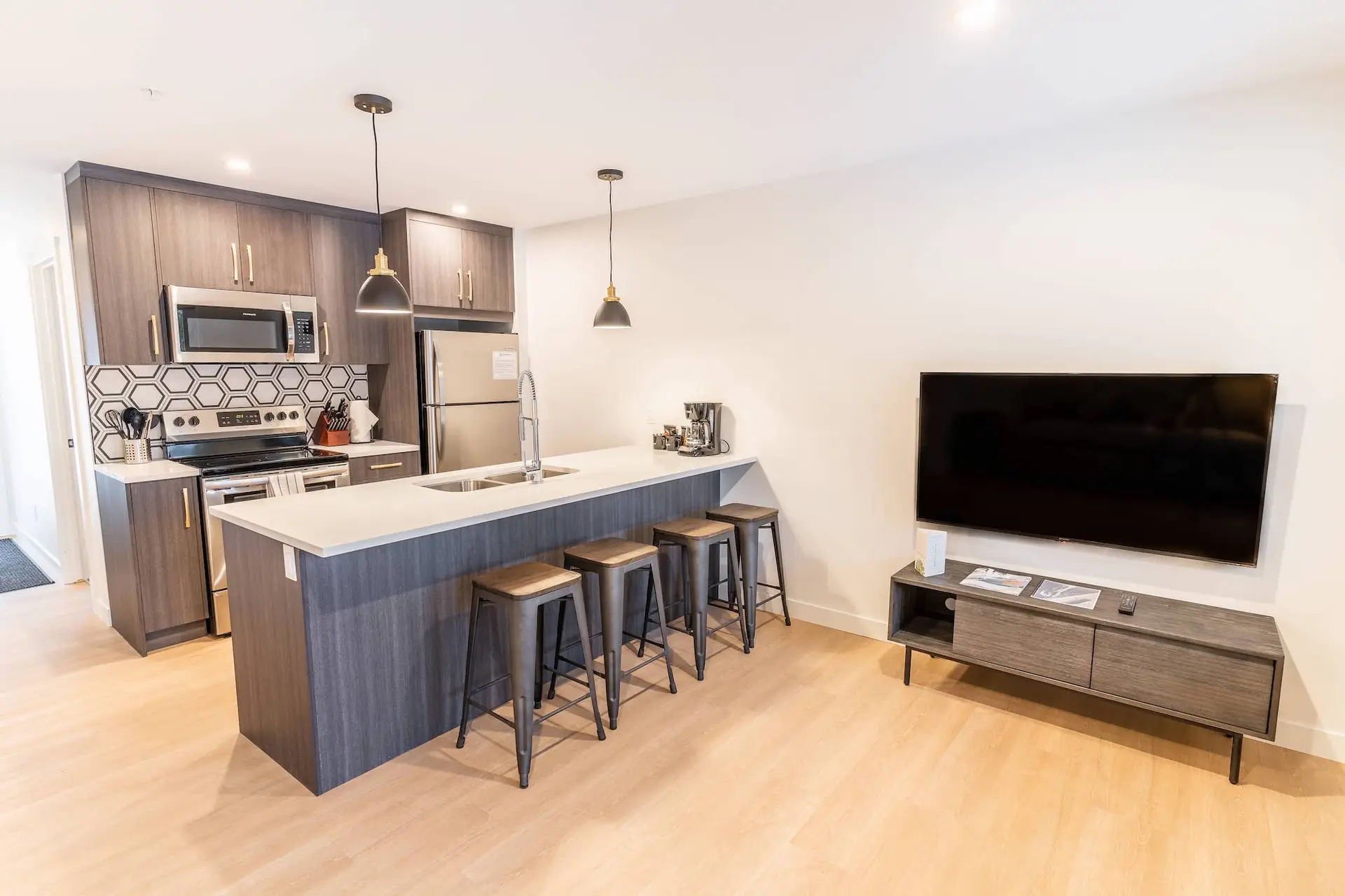 Modern kitchen and living area in Basecamp Resorts Revelstoke one bedroom suite.