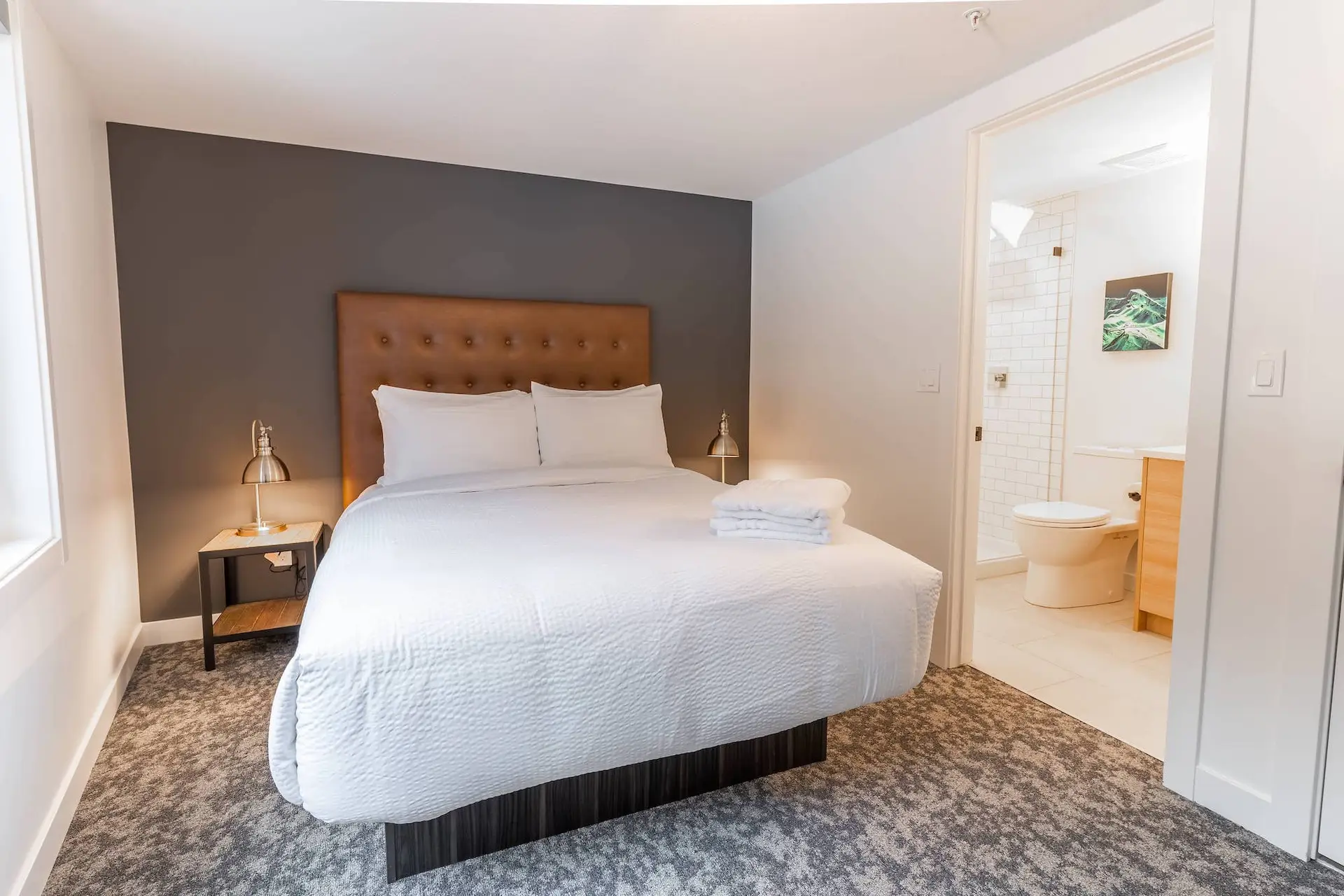 Basecamp Resorts Revelstoke two-bedroom suite with king bed and ensuite bathroom.