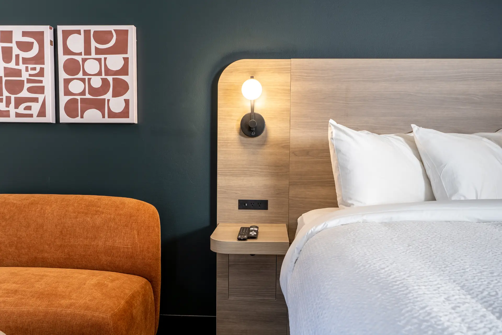 Basecamp Northwinds Revelstoke king room with orange sofa and modern decor