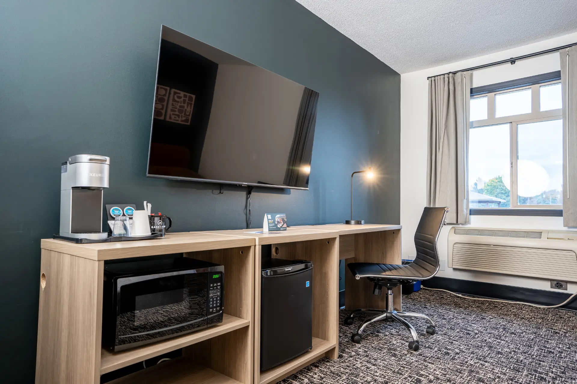 Basecamp Northwinds Revelstoke King room with TV, desk, and mini-fridge