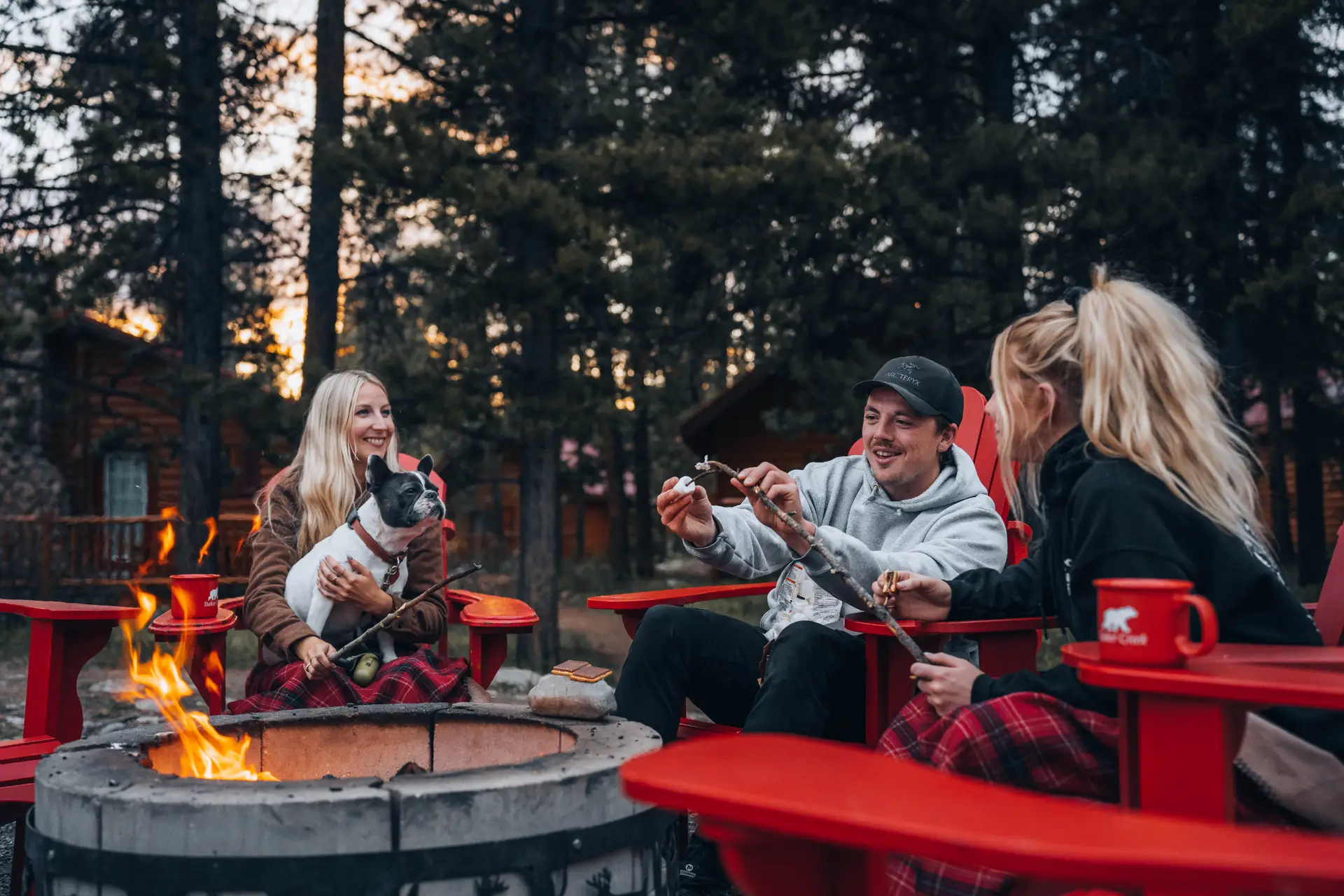 Group booking at Baker Creek: friends roasting marshmallows by fire pit