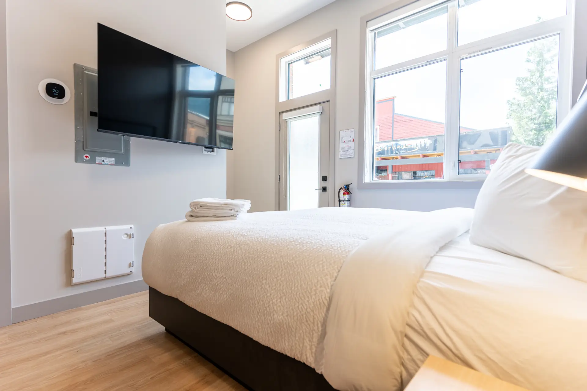 Revelstoke micro studio with a bed, TV, and large window
