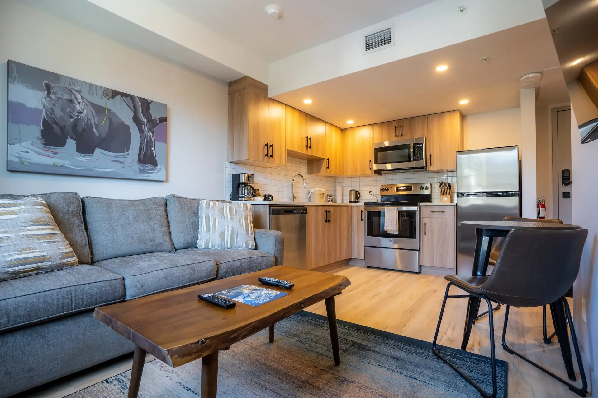 Cozy living area and kitchen in Basecamp Suites Banff one bedroom suite