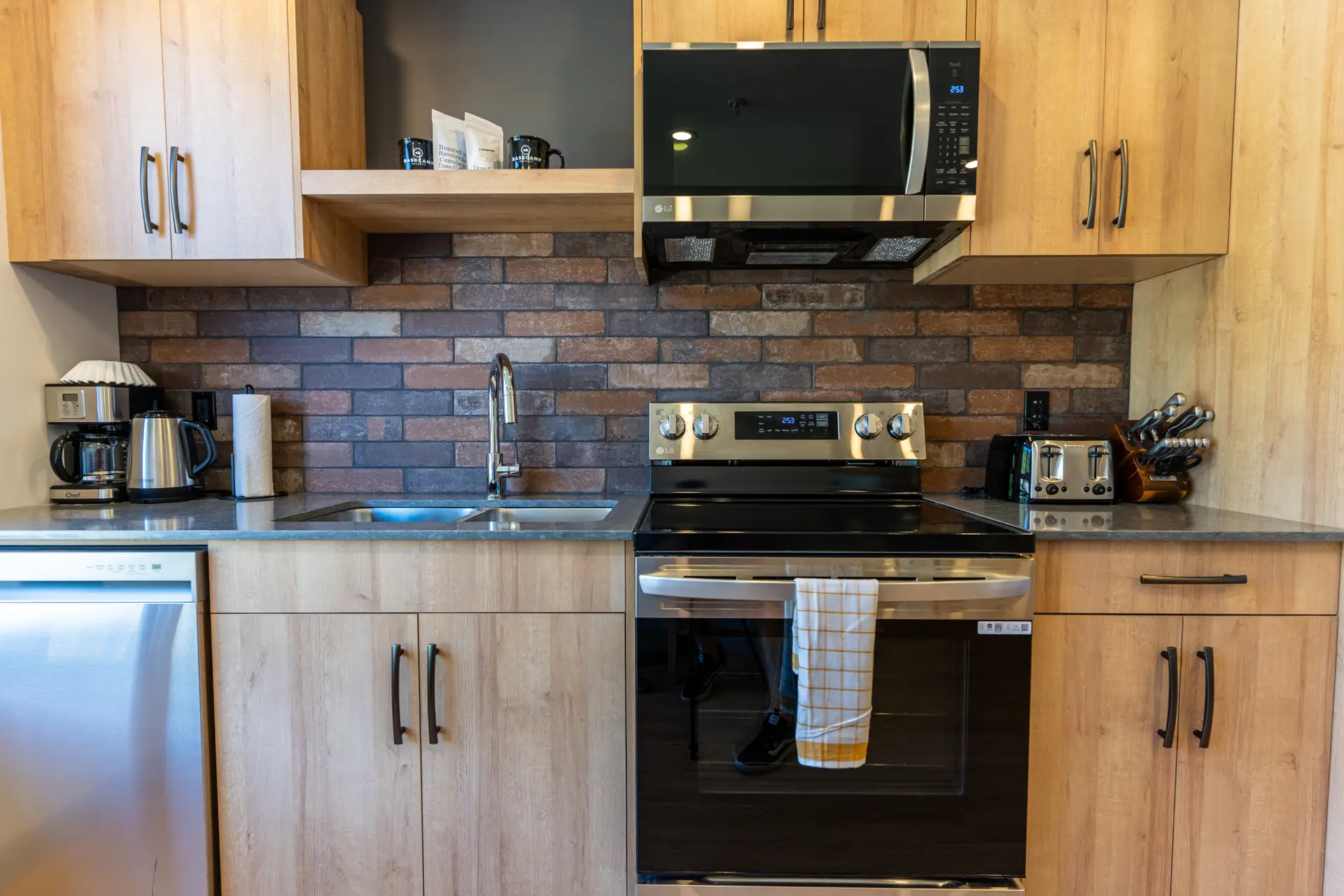 Modern kitchen in Basecamp Suites Revelstoke King Suite with stainless steel appliances.