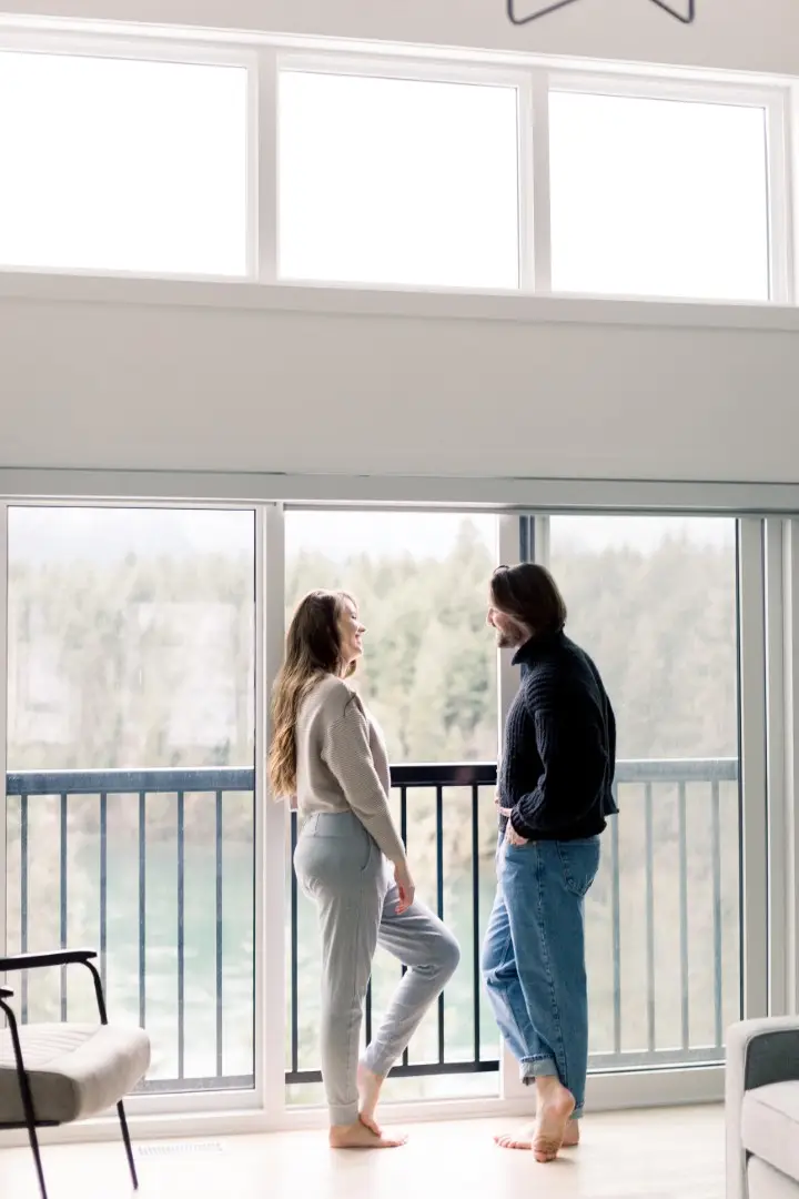Couple enjoying mountain view from Basecamp Resorts Revelstoke balcony
