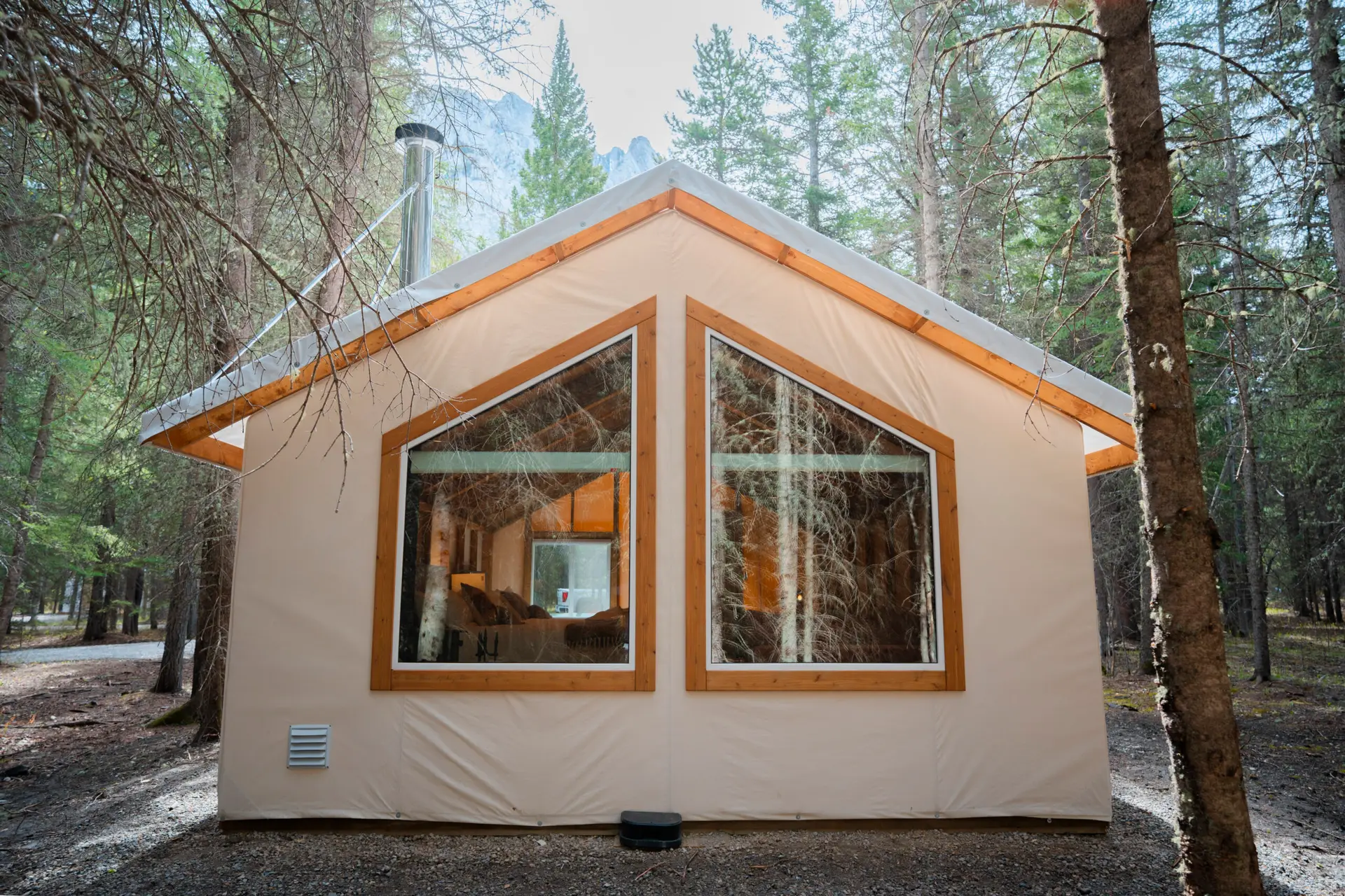 Basecamp Sundance Family Tent with large triangular windows in a forest setting.
