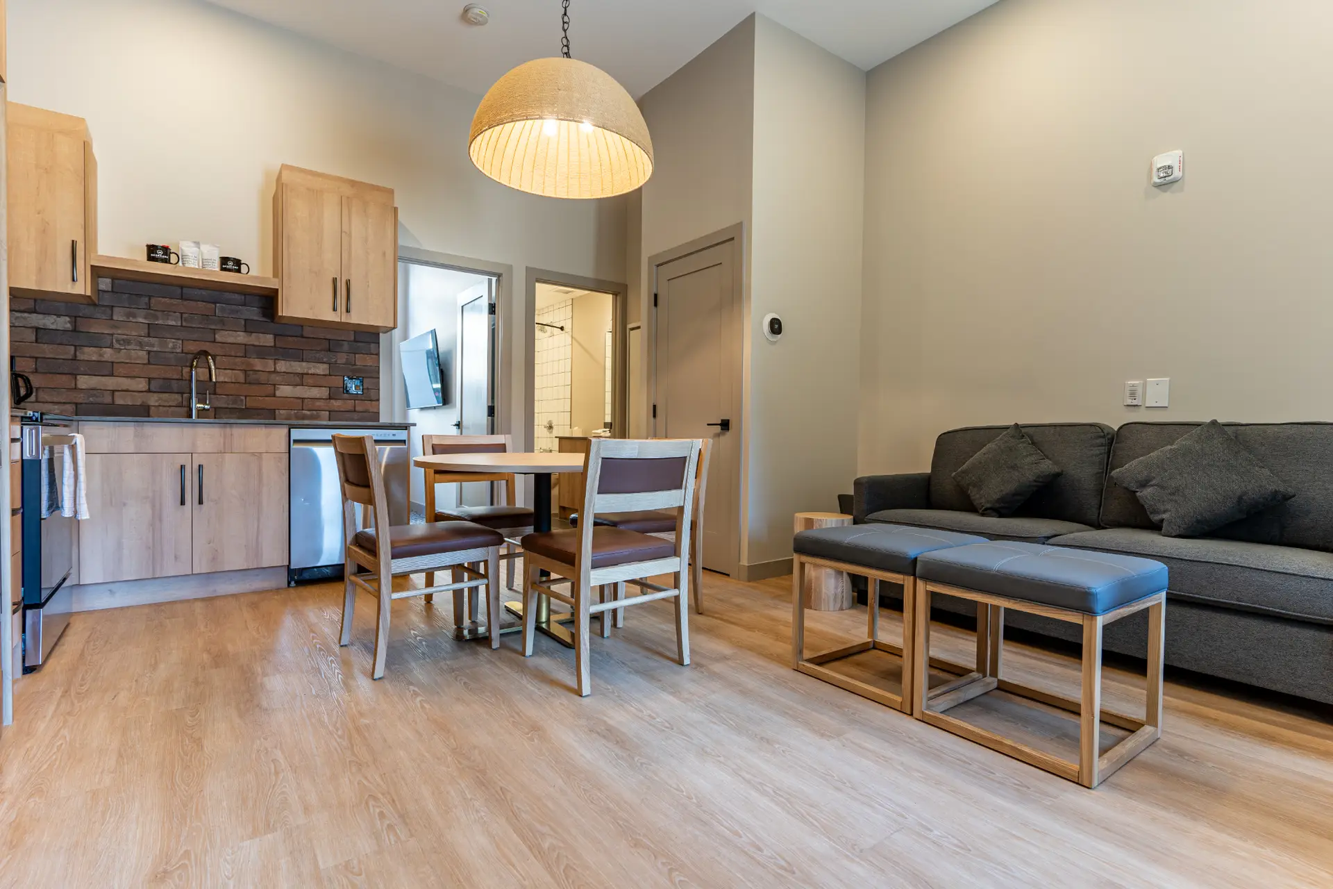 Revelstoke Basecamp Suites: Modern one-bedroom suite with kitchen, dining, and living area.