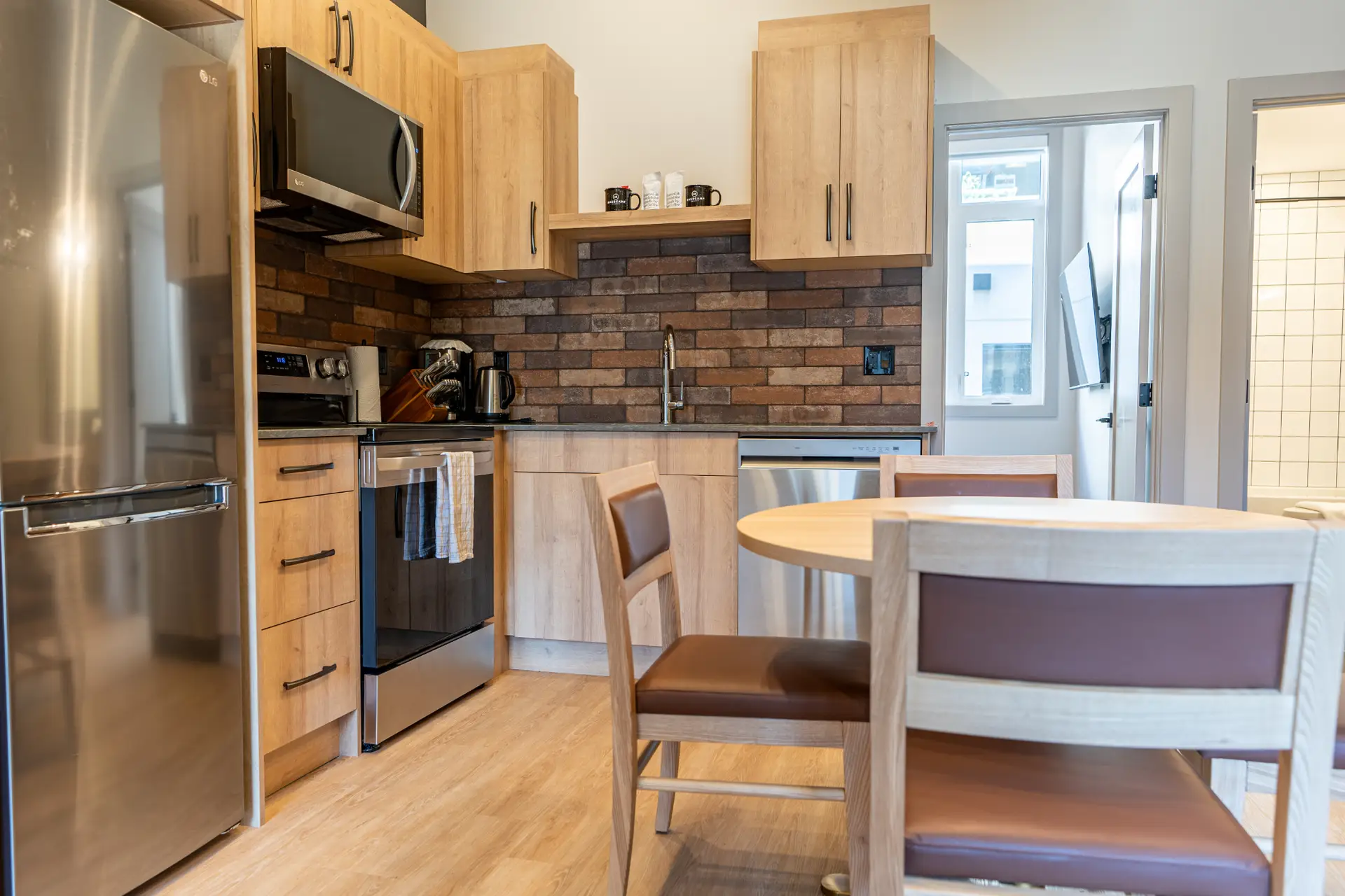 Modern kitchen in Basecamp Suites Revelstoke Superior One Bedroom Suite with stainless steel appliances
