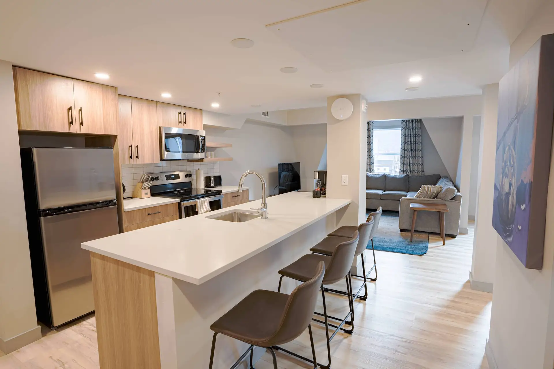 Modern kitchen and living area in a Basecamp Suites Banff Superior Three Bedroom Suite.