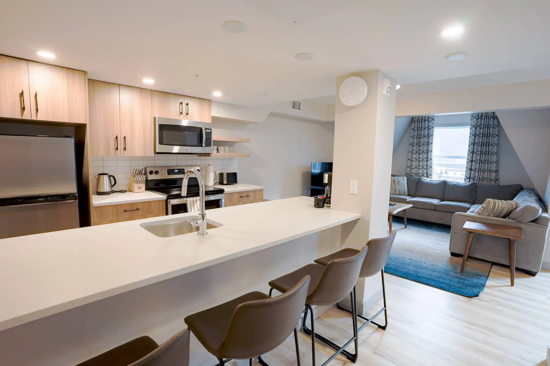 Basecamp Suites Banff: Modern kitchen and living area in a three-bedroom suite.