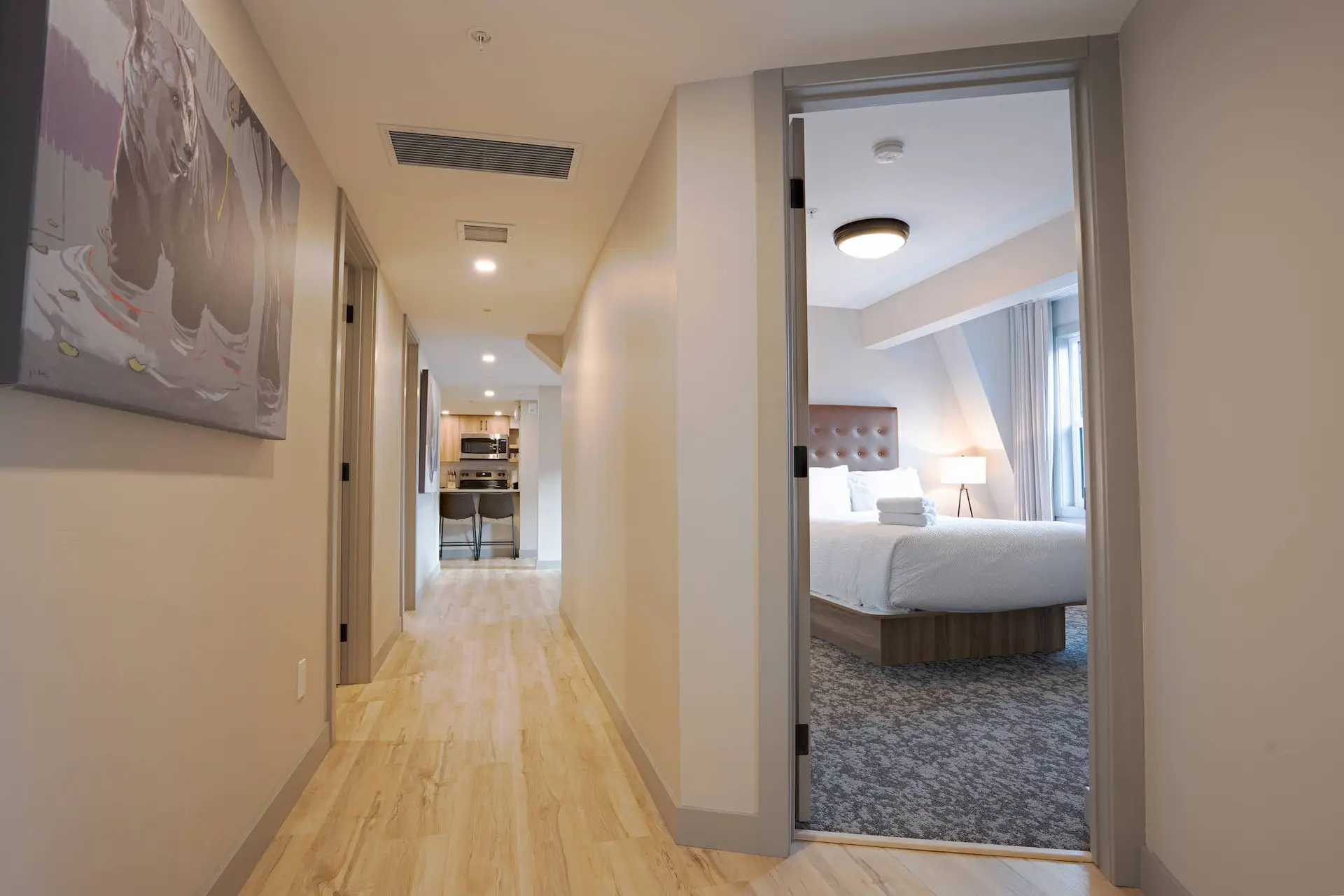 Hallway view of a Basecamp Suites Banff Superior Three Bedroom Suite with open bedroom door