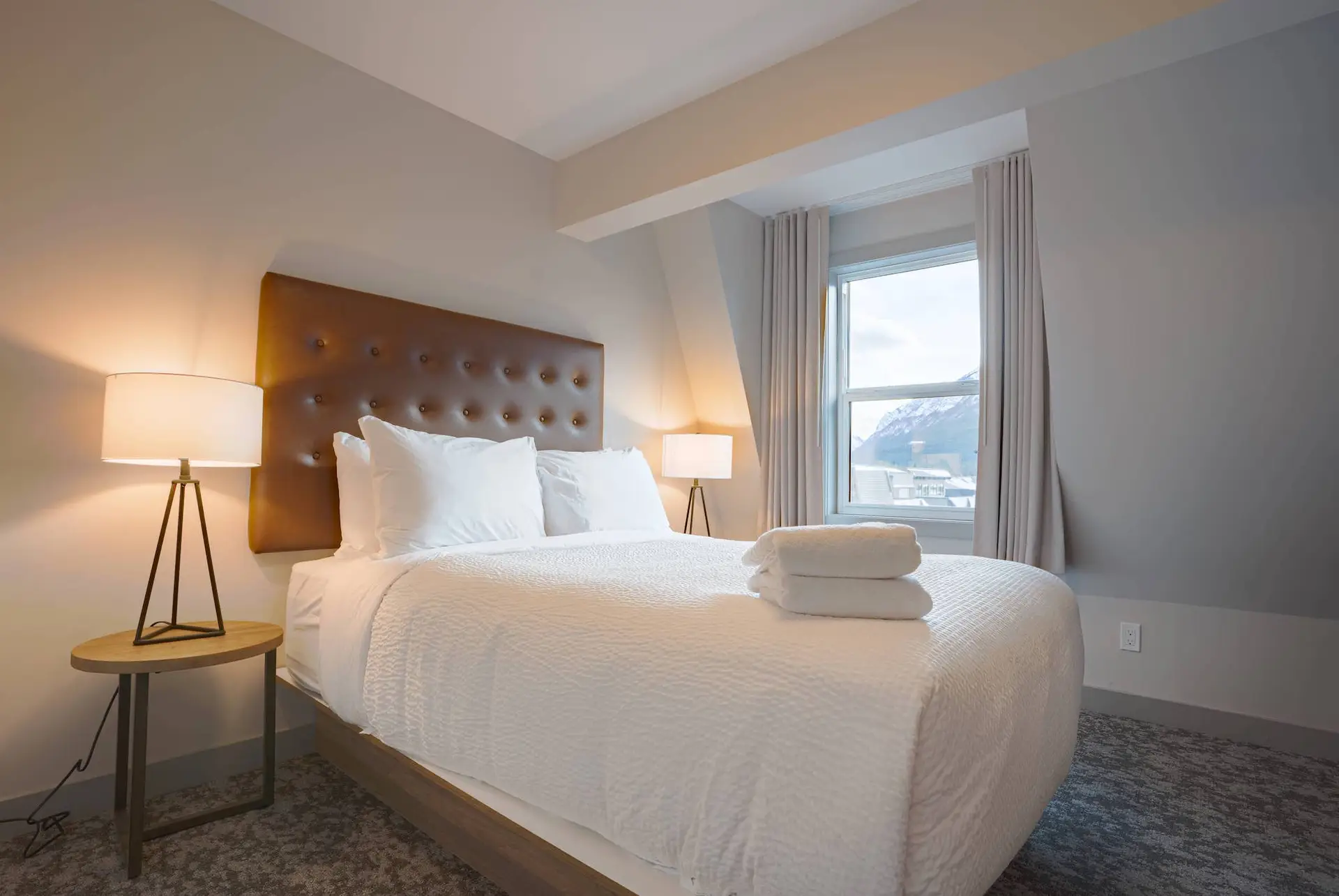 Basecamp Suites Banff Superior Suite bedroom with king bed and mountain view